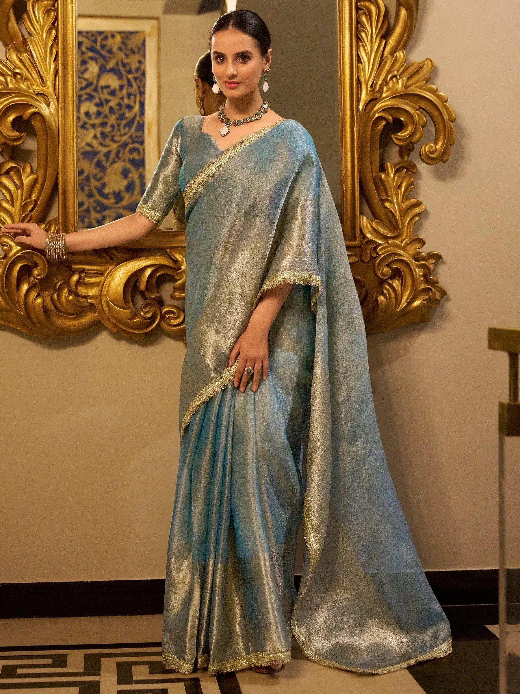 Elegant blue and gold saree with shimmering fabric and intricate border, perfect for festive occasions