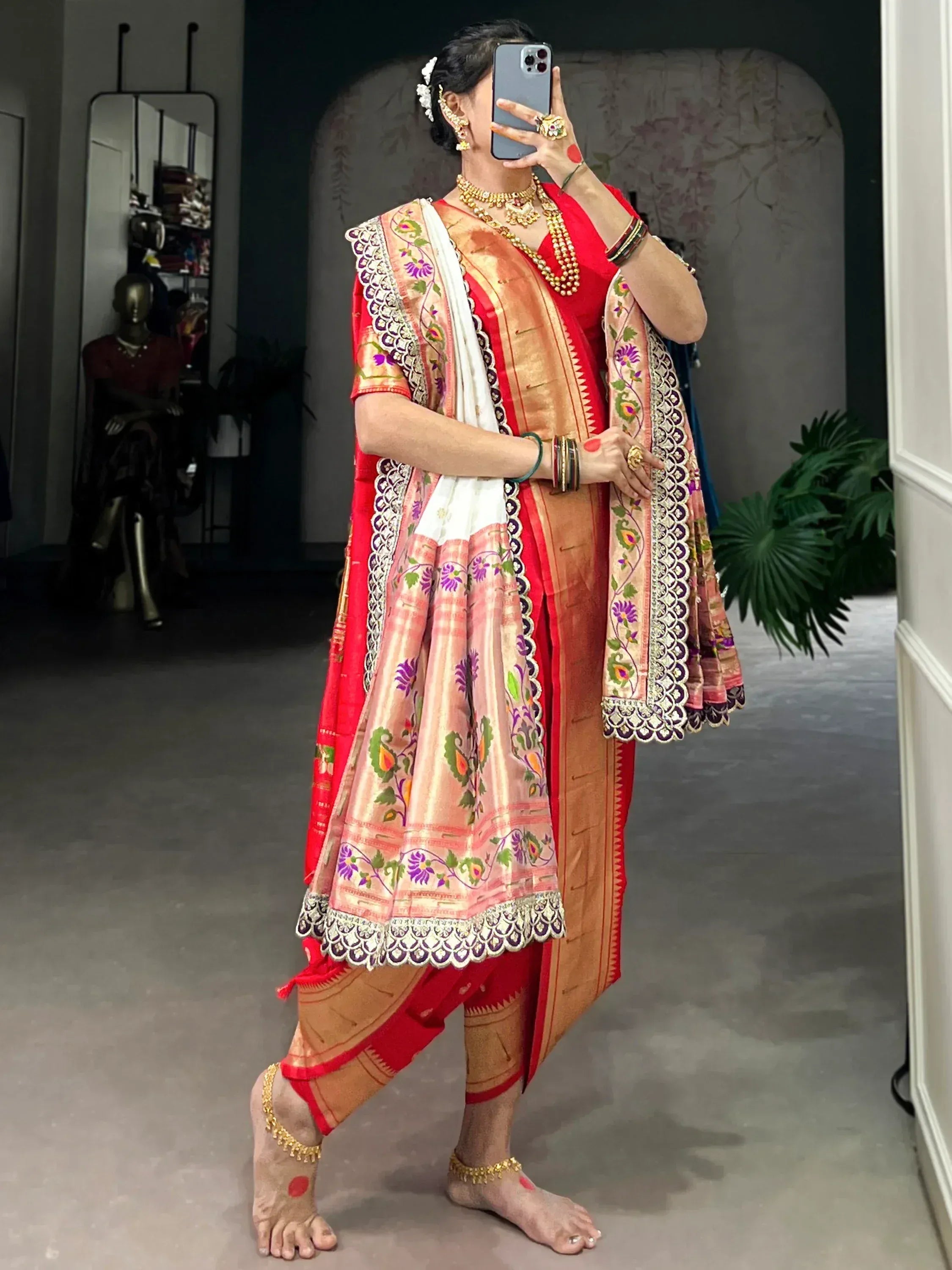 Elegant Indian ethnic wear with floral embroidery, red and gold saree, and traditional jewelry