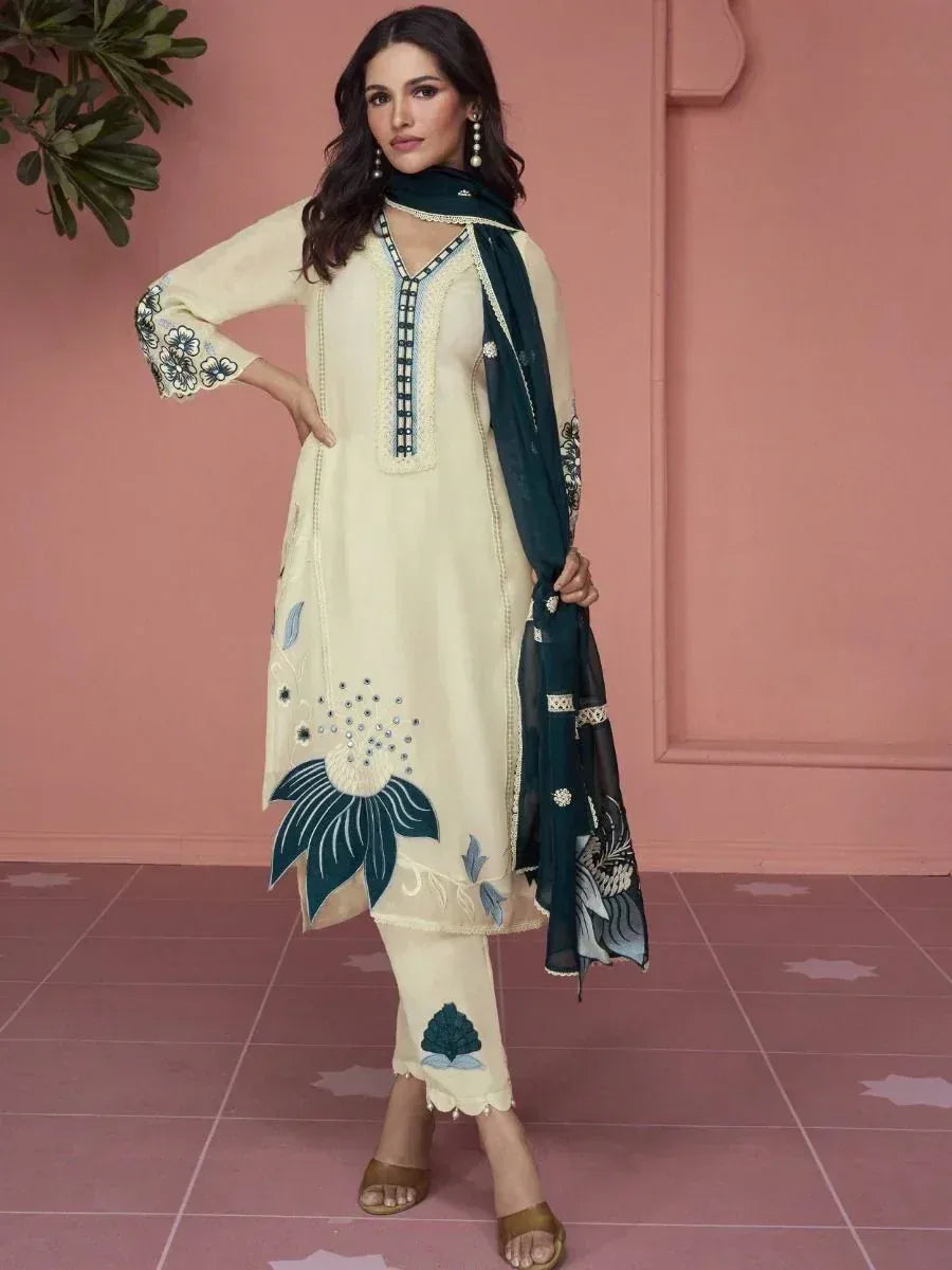 Woman wearing cream embroidered salwar kameez with navy blue dupatta and floral patterns