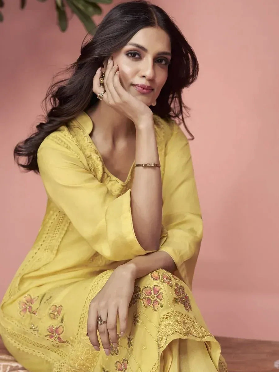 Yellow embroidered ethnic gown with floral detailing, perfect for Indian occasions