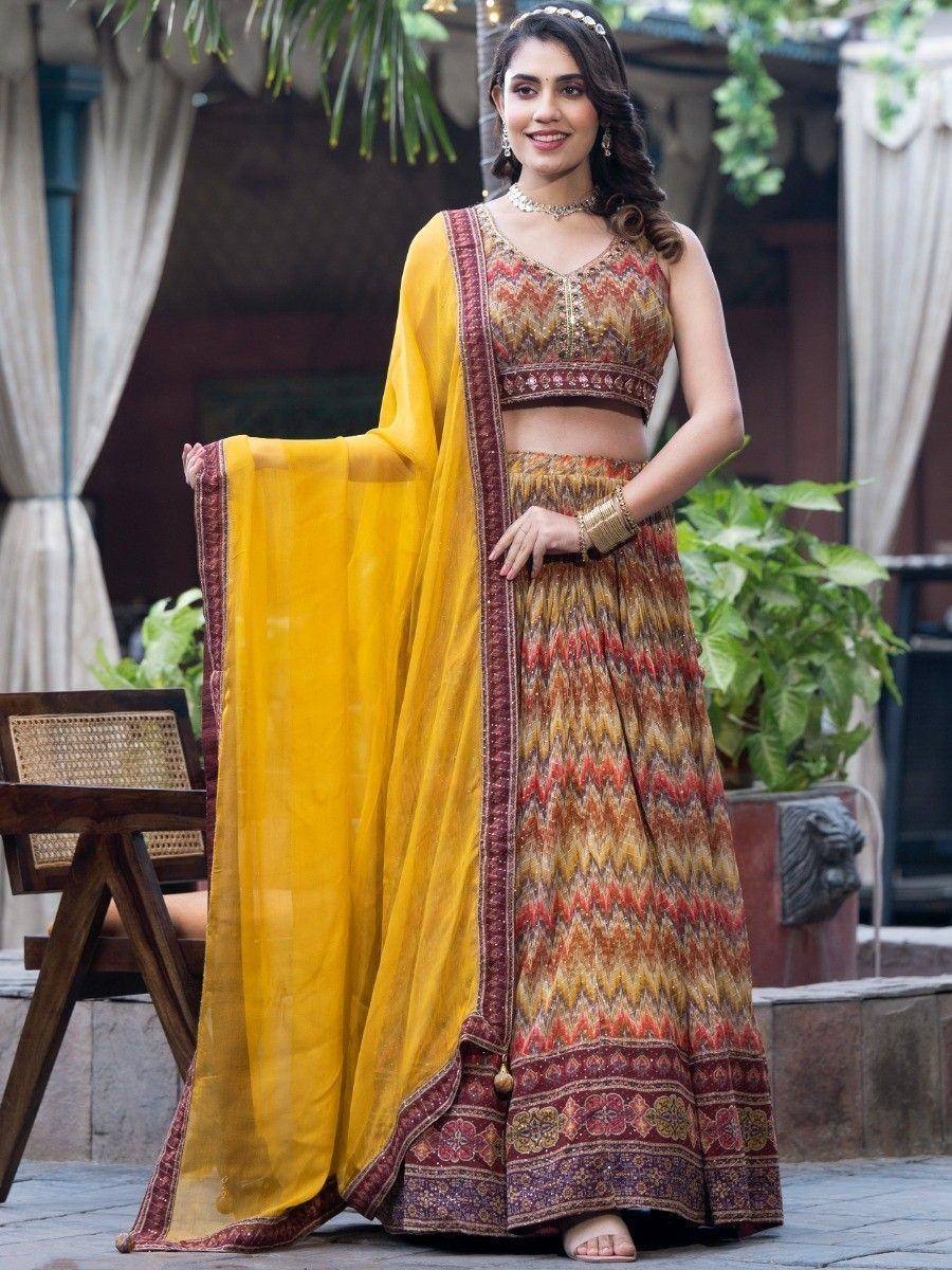 Woman in vibrant yellow and maroon printed lehenga choli with dupatta, perfect for Indian ethnic occasions