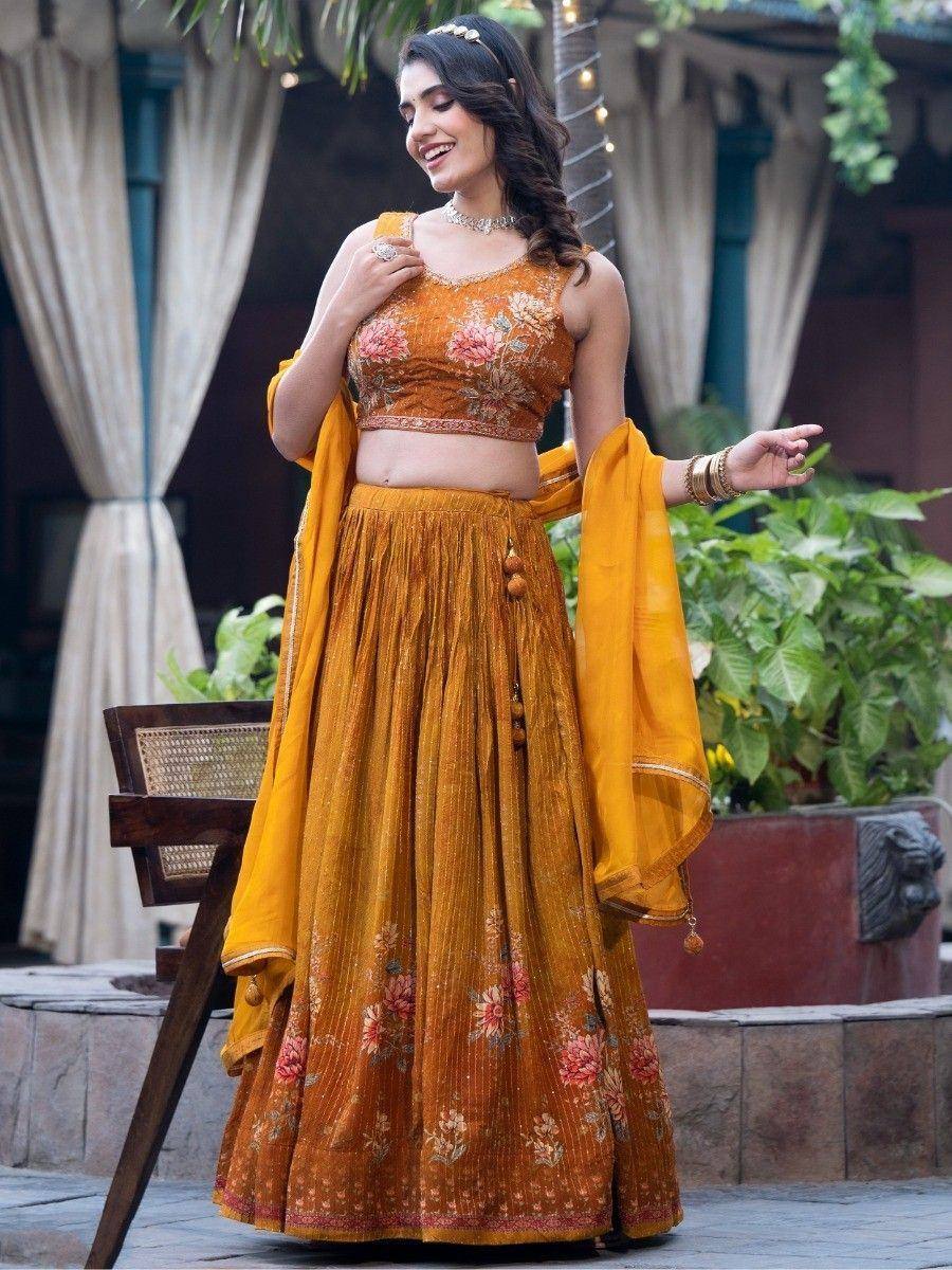 Woman in mustard floral lehenga choli with dupatta, perfect for Indian ethnic occasions