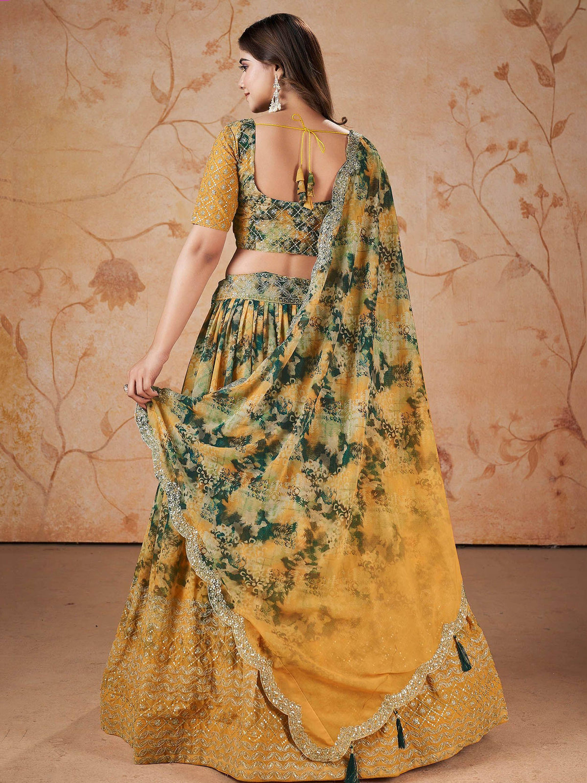 Yellow and green printed lehenga choli with embroidered border and tassels, ethnic wear for women