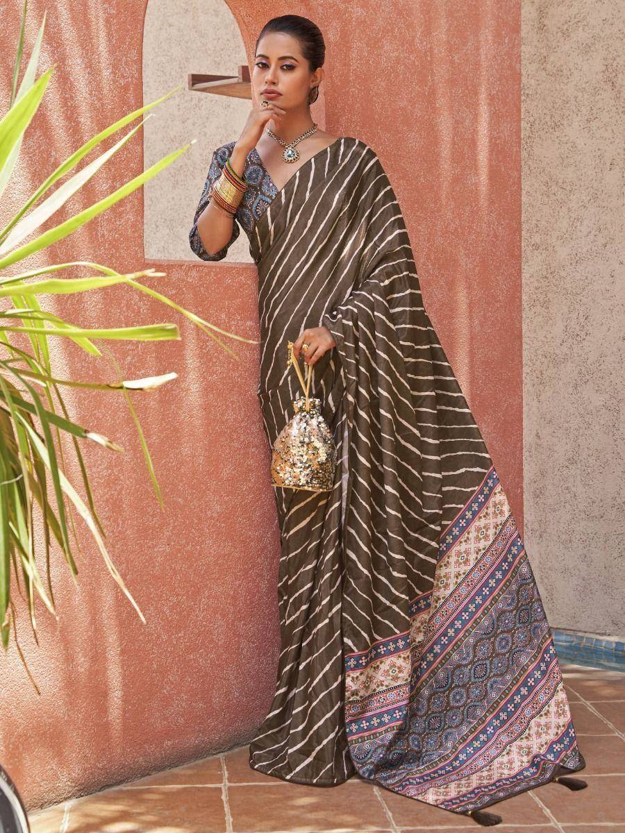 Elegant brown striped saree with colorful border, paired with designer blouse and sequin potli bag for ethnic wear.
