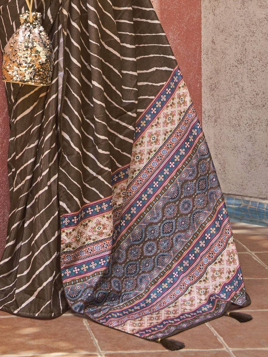 Brown and white striped saree with colorful embroidered border and sequin potli bag