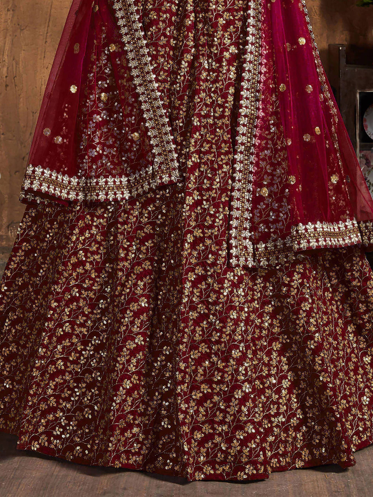 Maroon velvet lehenga choli with gold floral embroidery and sequin work, perfect for weddings and festivals