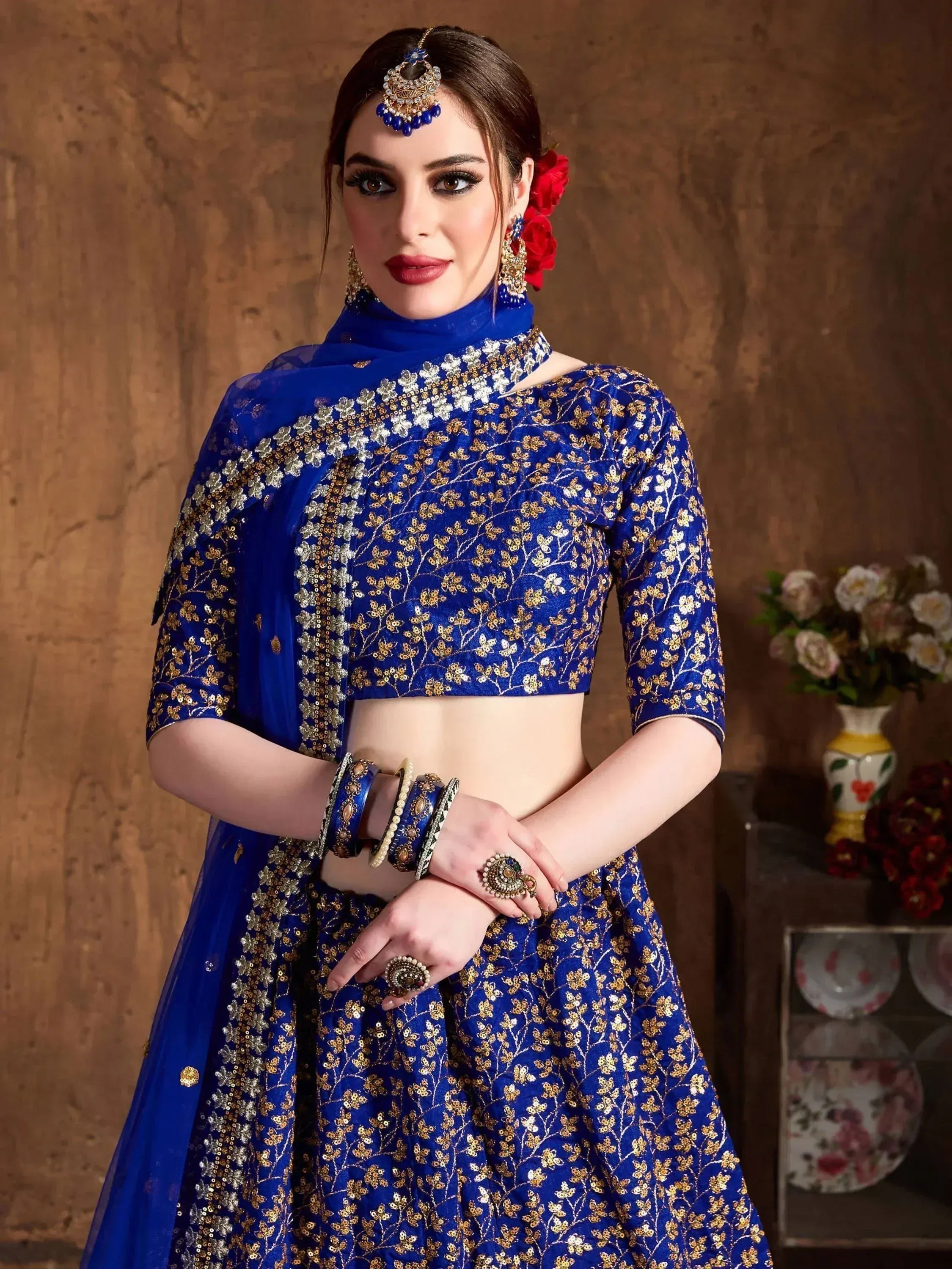 Royal blue embroidered lehenga choli with gold floral work, perfect for Indian weddings and festive occasions.