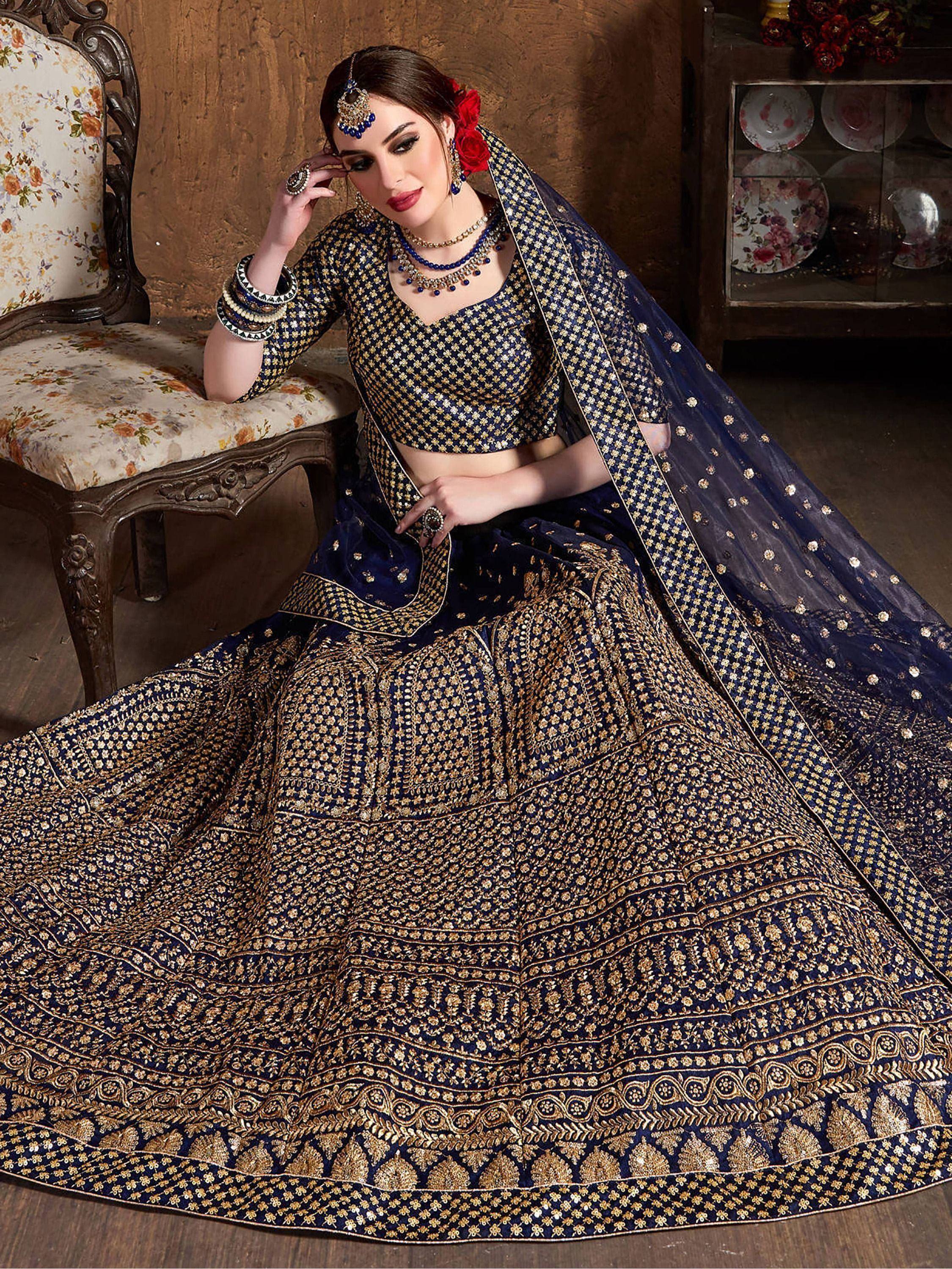 Elegant navy blue lehenga choli with gold embroidery, perfect for Indian weddings and festive occasions.
