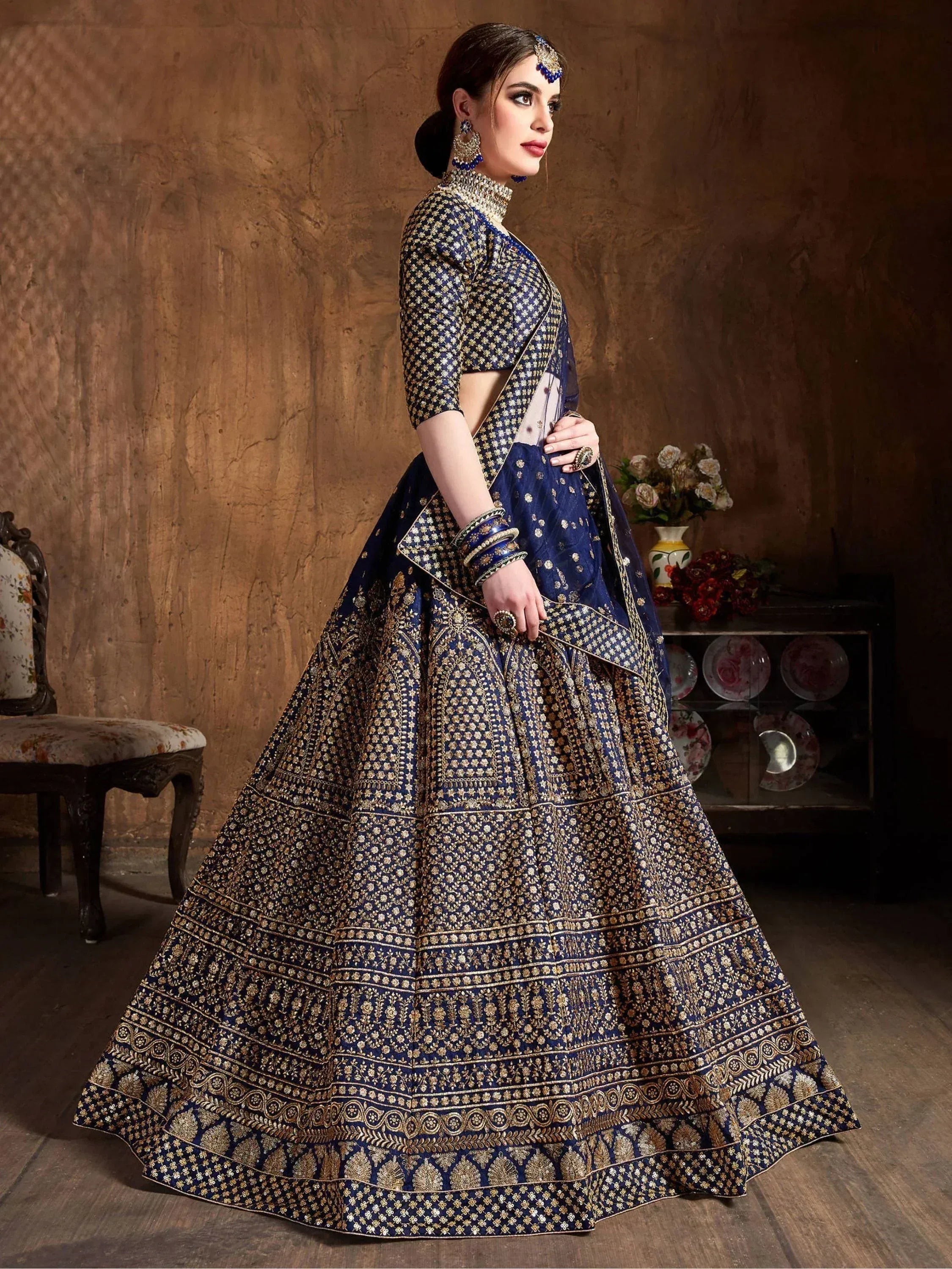 Blue and gold embroidered lehenga choli with intricate patterns, perfect for Indian ethnic wear and weddings.