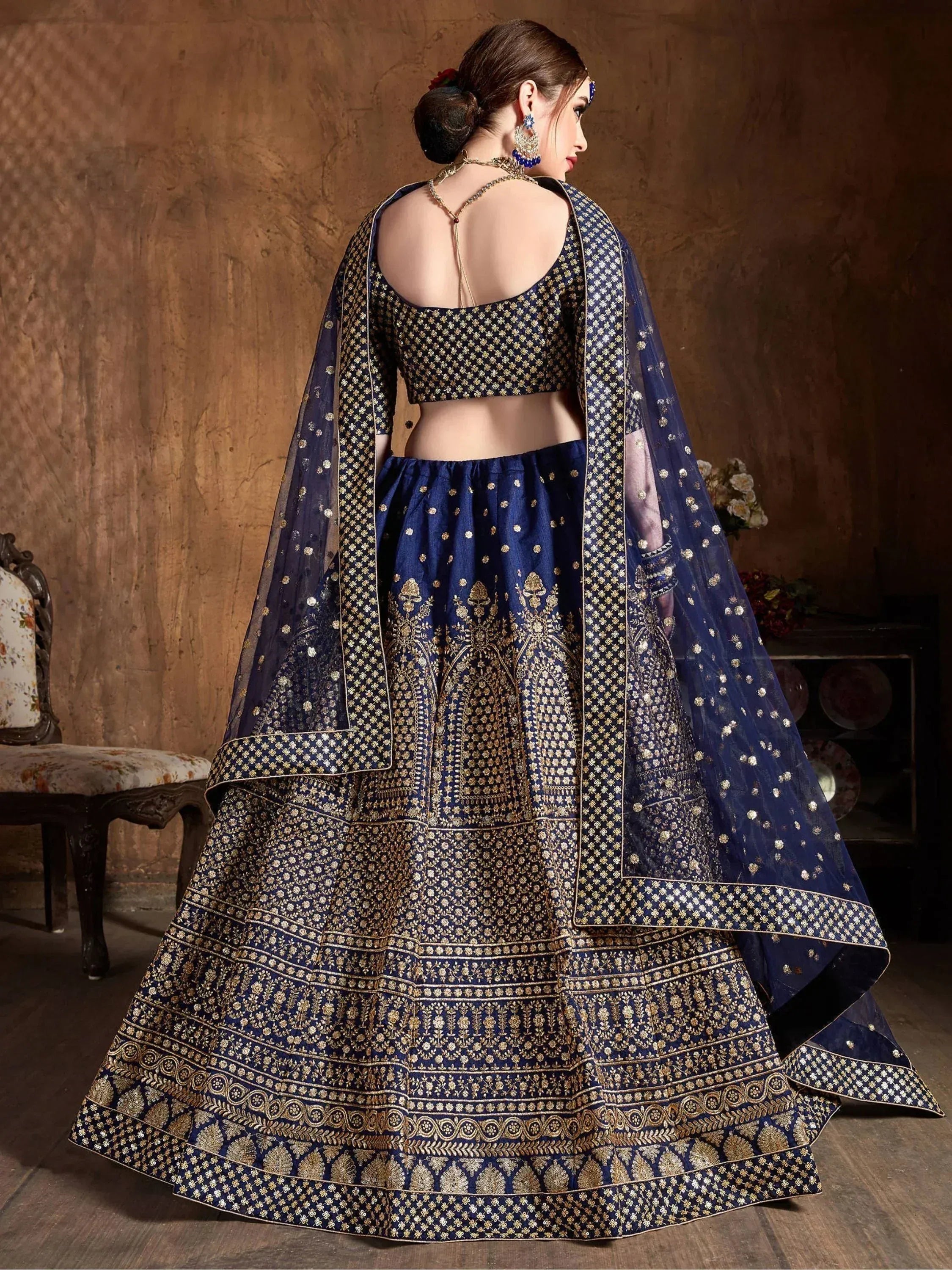 Navy blue designer lehenga choli with gold embroidery, perfect for Indian weddings and festive occasions.