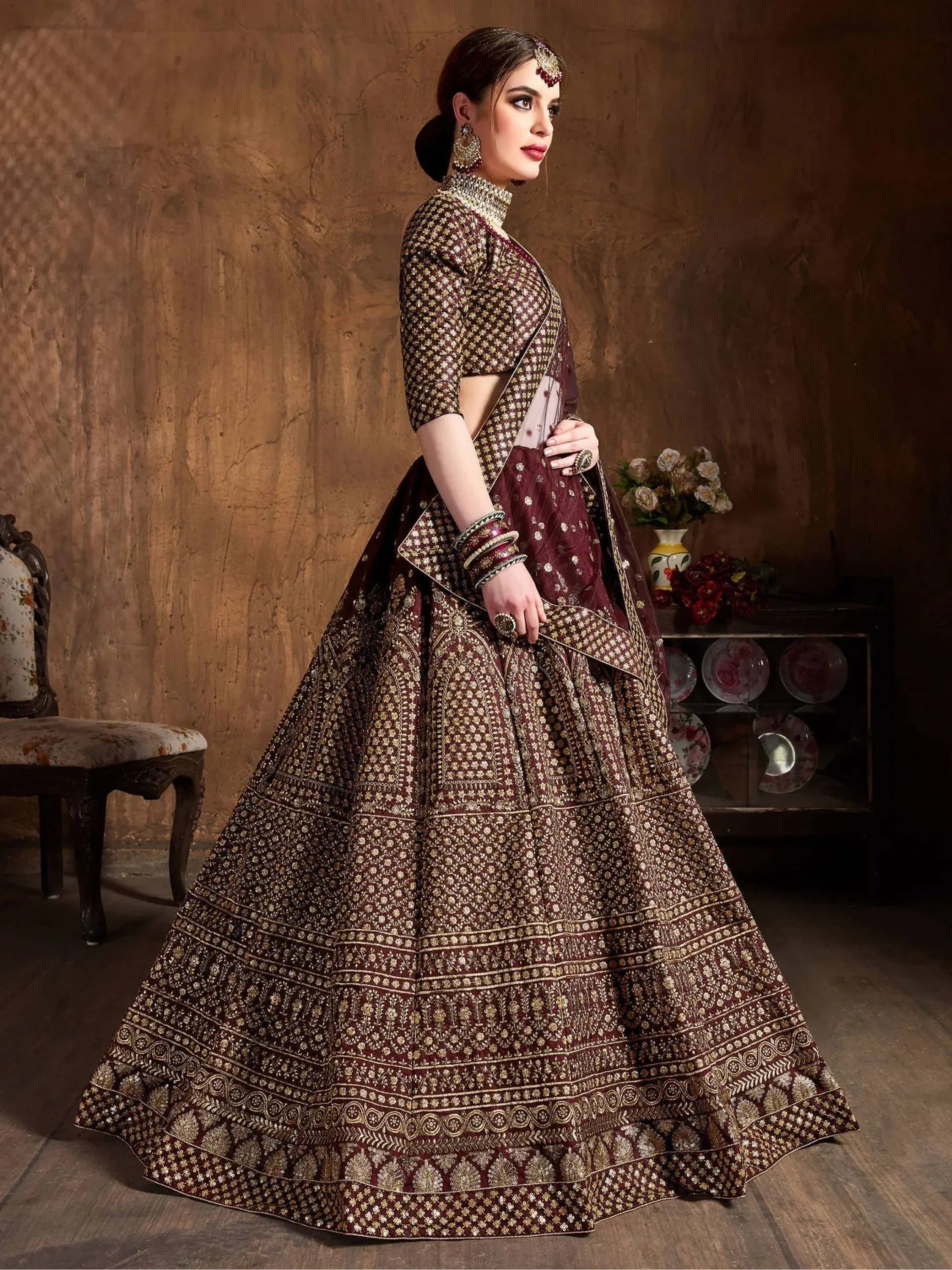 Maroon designer lehenga choli with gold embroidery, perfect for Indian weddings and festive occasions.