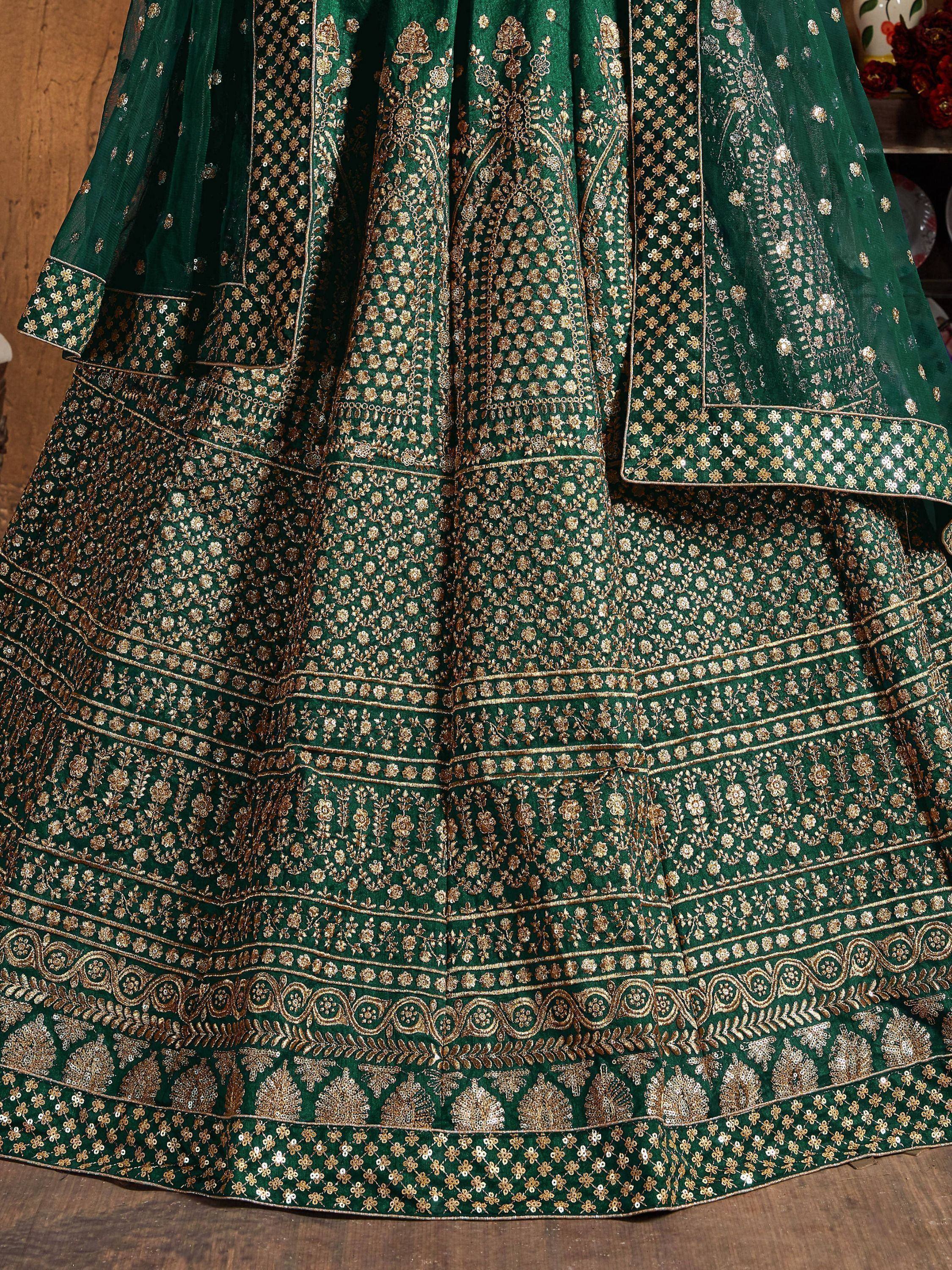 Emerald green lehenga choli with intricate gold embroidery and sequin detailing, perfect for Indian ethnic wear.