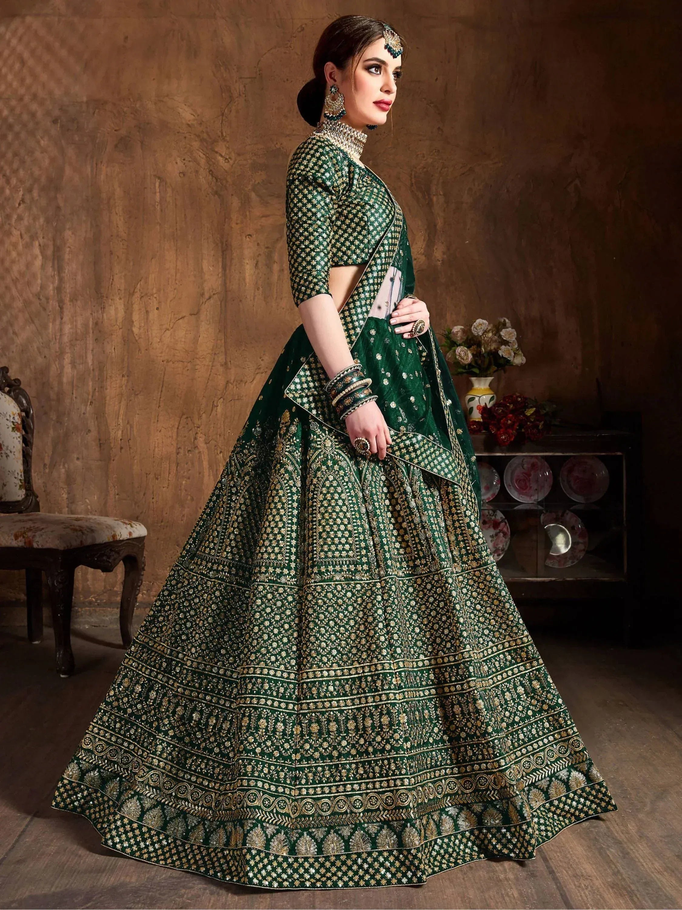 Emerald green designer lehenga choli with gold embroidery, perfect for Indian weddings and festive occasions