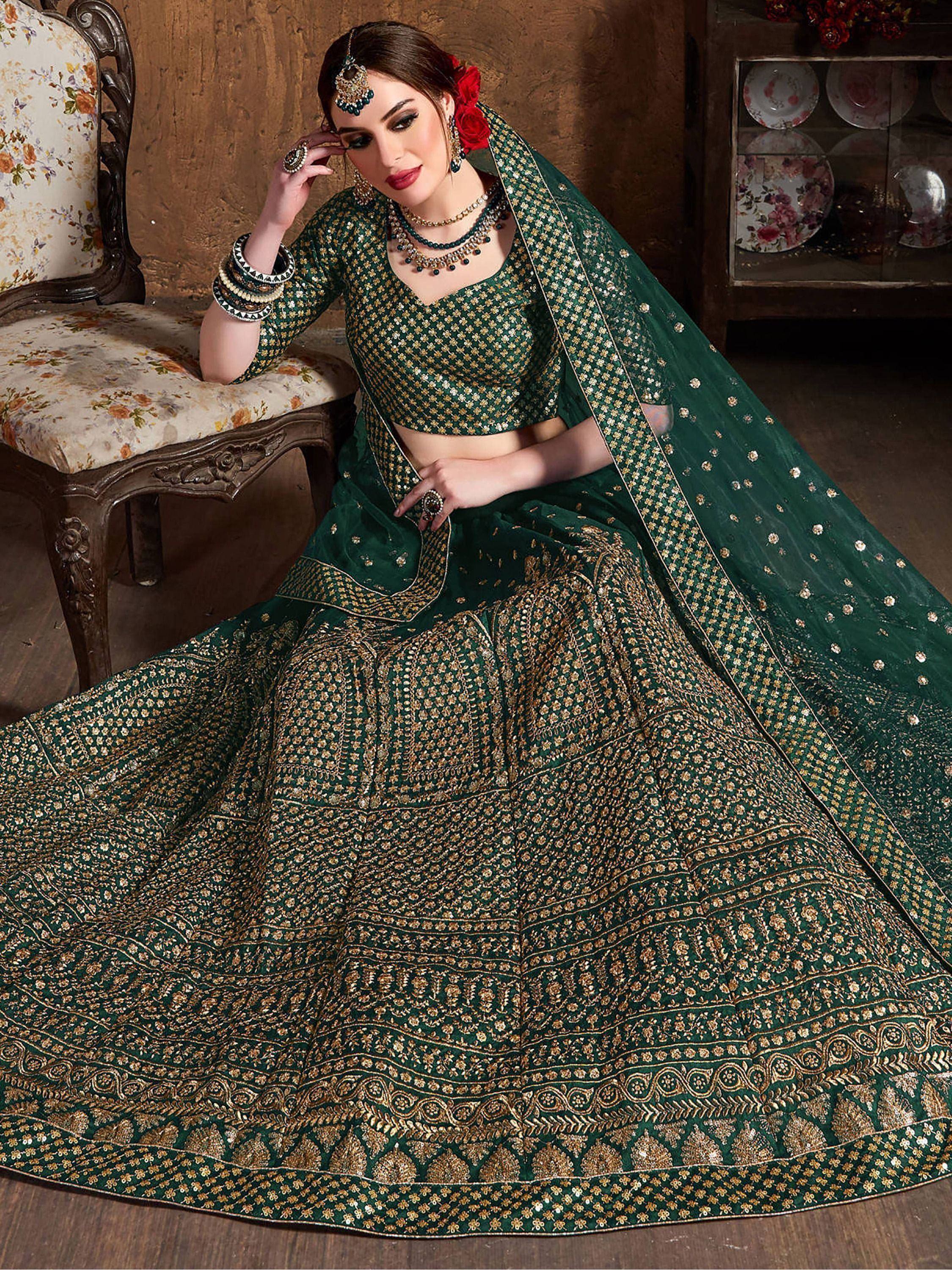Emerald green designer lehenga choli with gold embroidery, perfect for Indian weddings and festive occasions.