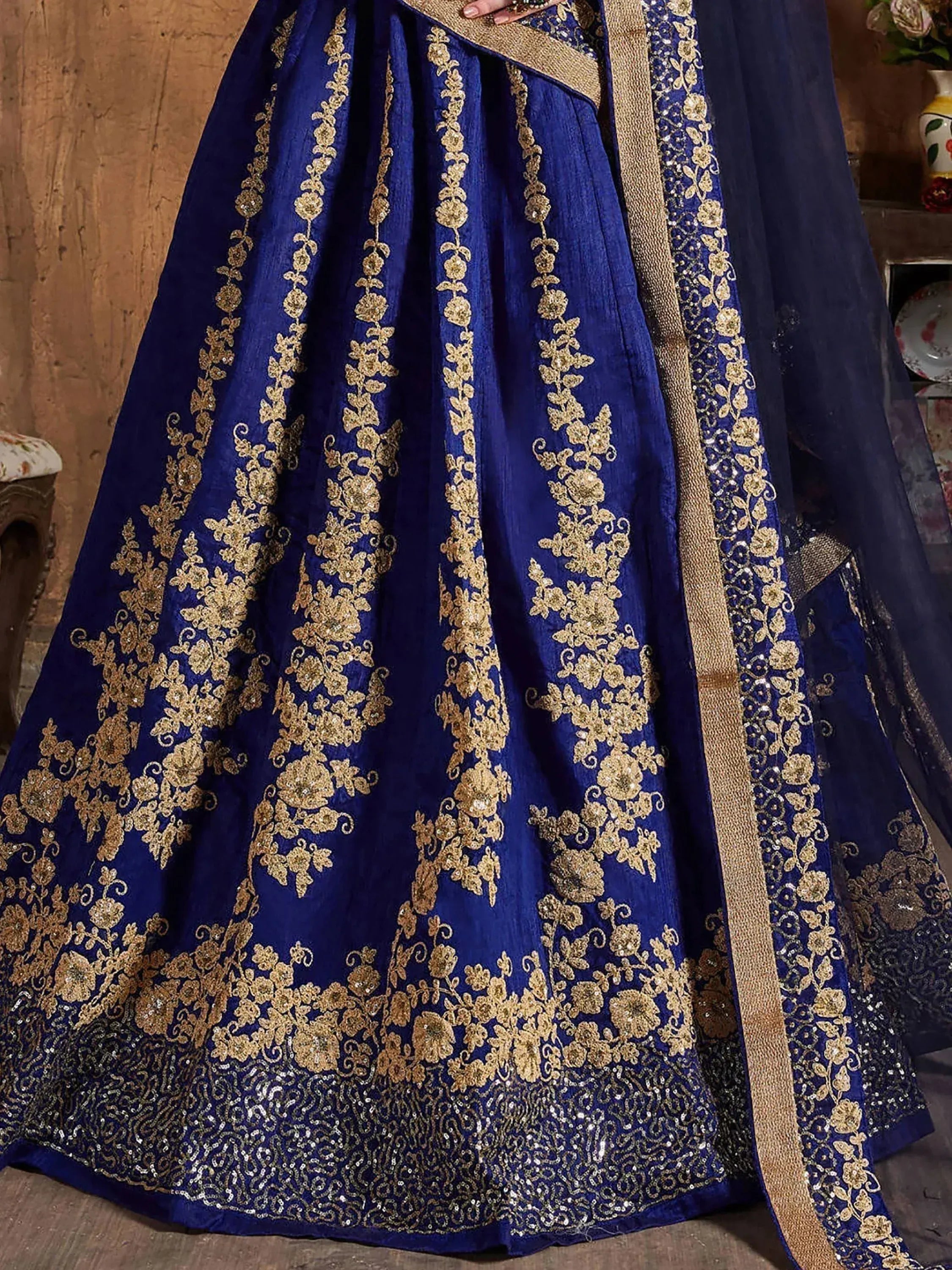 Royal blue lehenga choli with gold floral embroidery and sequin detailing, perfect for Indian ethnic wear.