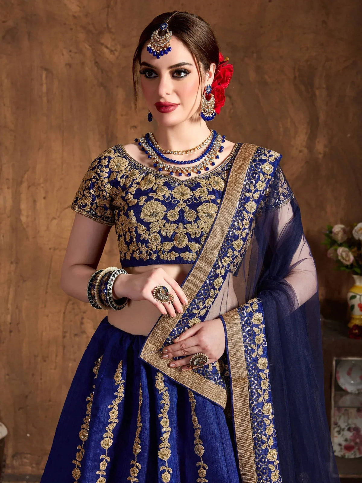 Royal blue lehenga choli with gold floral embroidery, perfect for Indian weddings and festive occasions.
