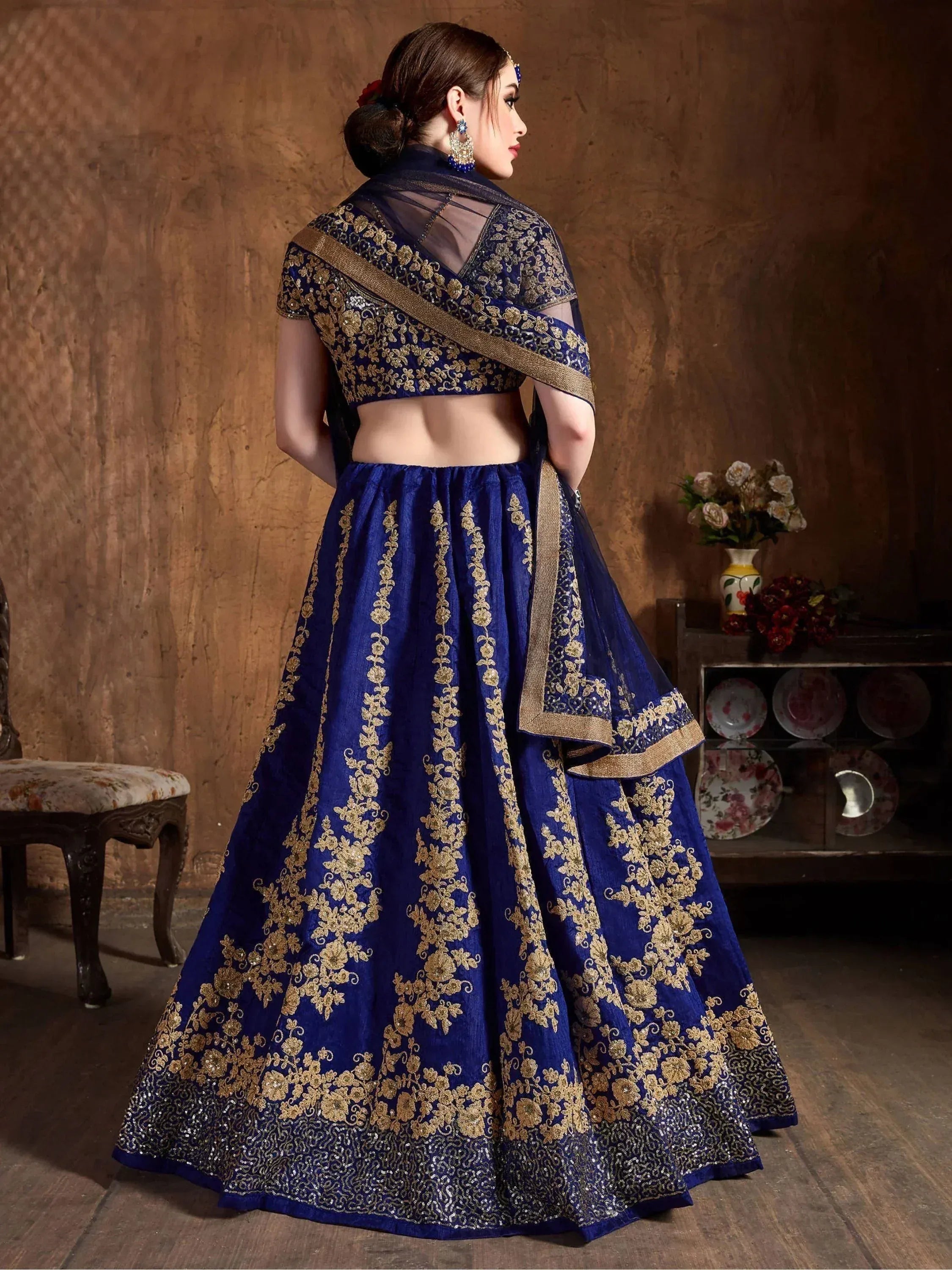 Royal blue lehenga choli with gold embroidery, sheer dupatta, perfect for Indian weddings and festive occasions.