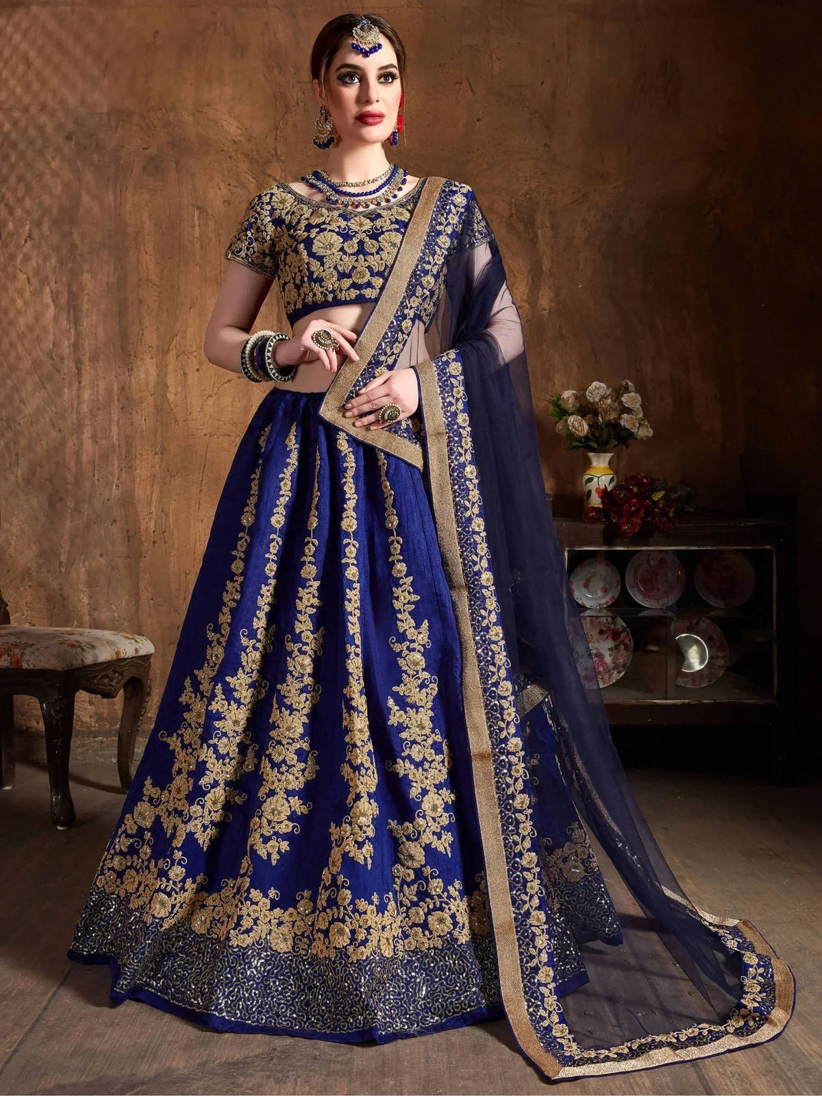 Royal blue lehenga choli with gold embroidery, perfect for Indian weddings and festive occasions.