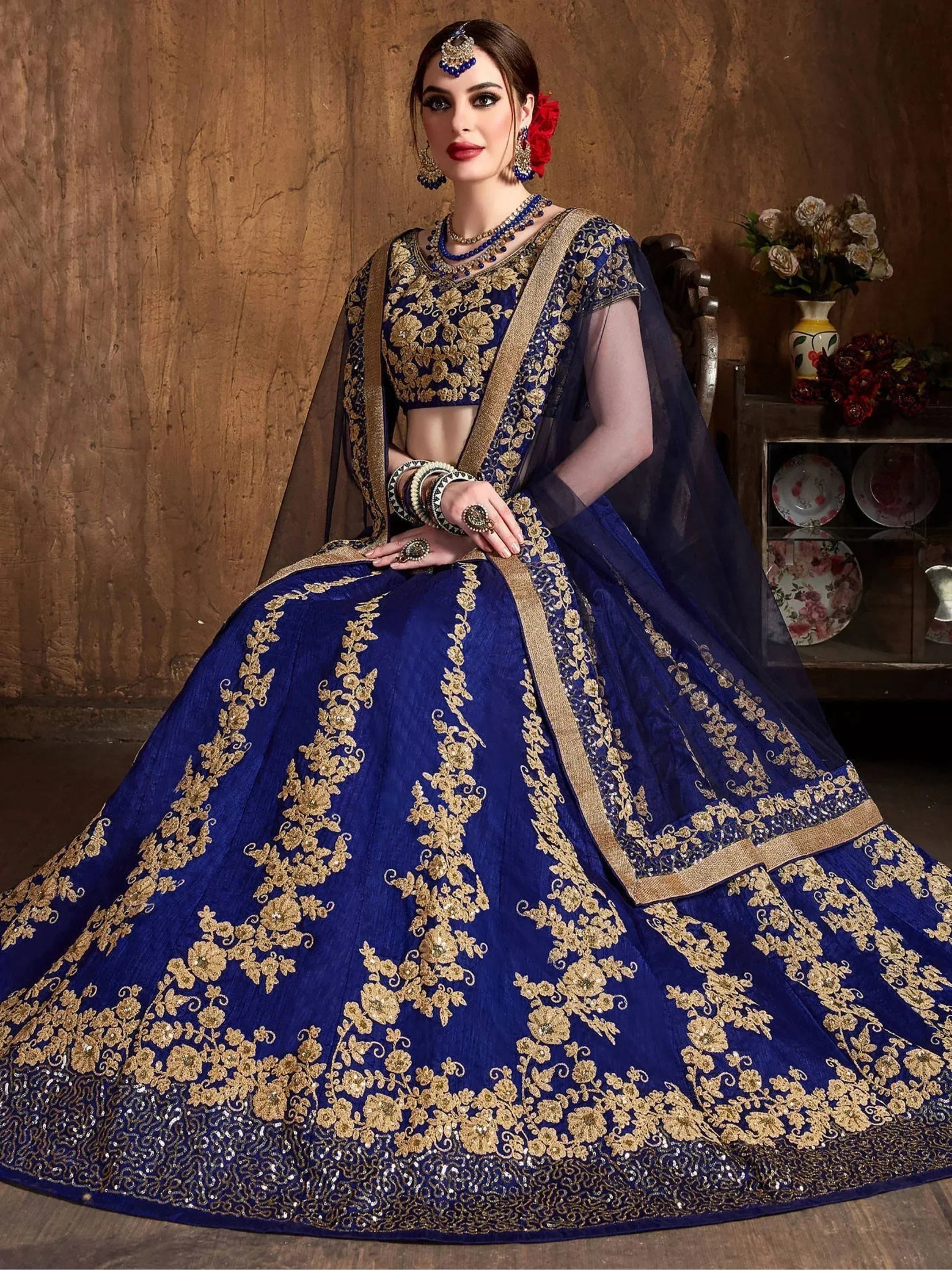 Royal blue designer lehenga choli with gold floral embroidery, perfect for Indian weddings and festive occasions.