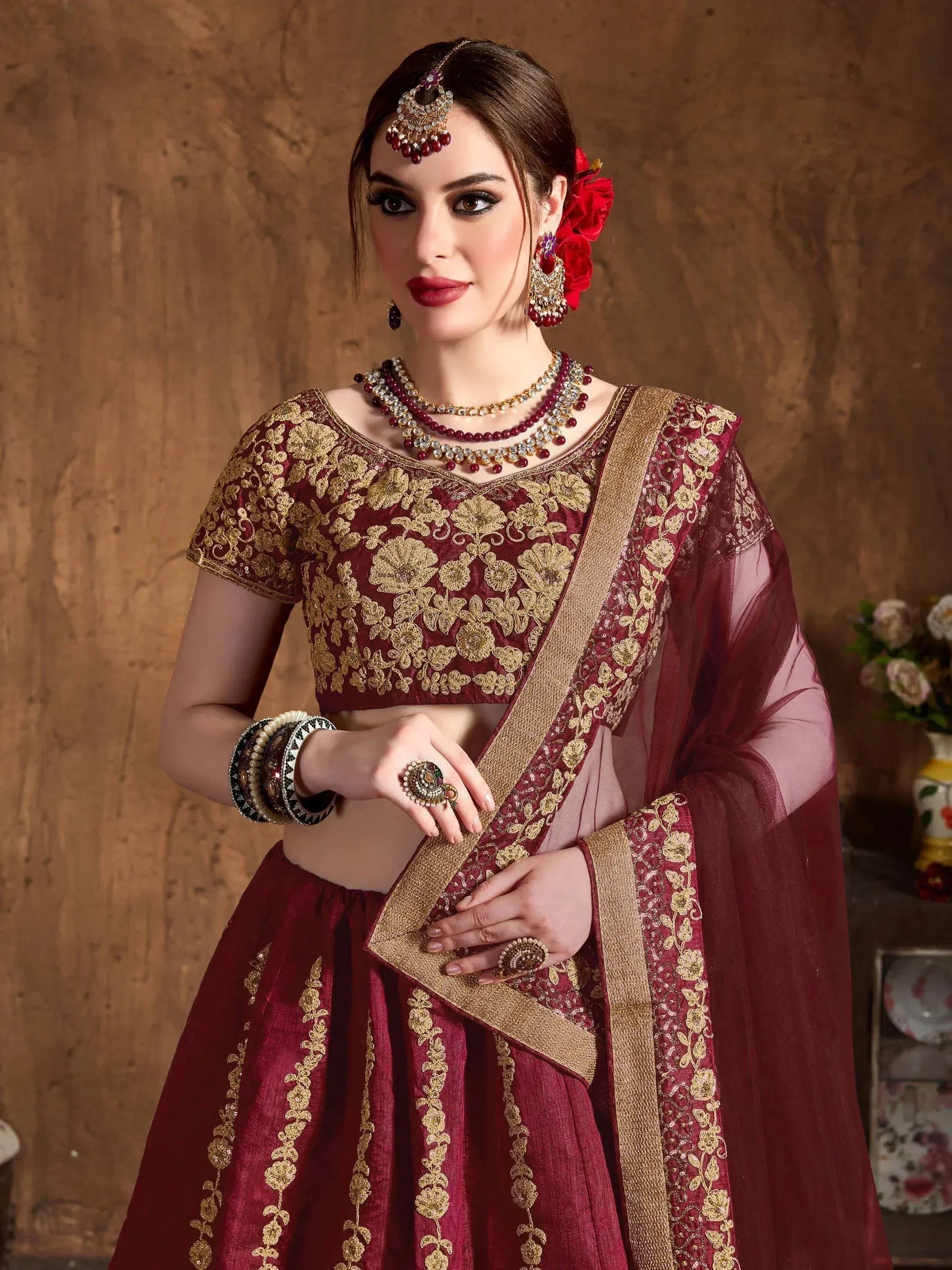 Maroon and gold embroidered lehenga choli with matching dupatta, traditional Indian ethnic wear for weddings
