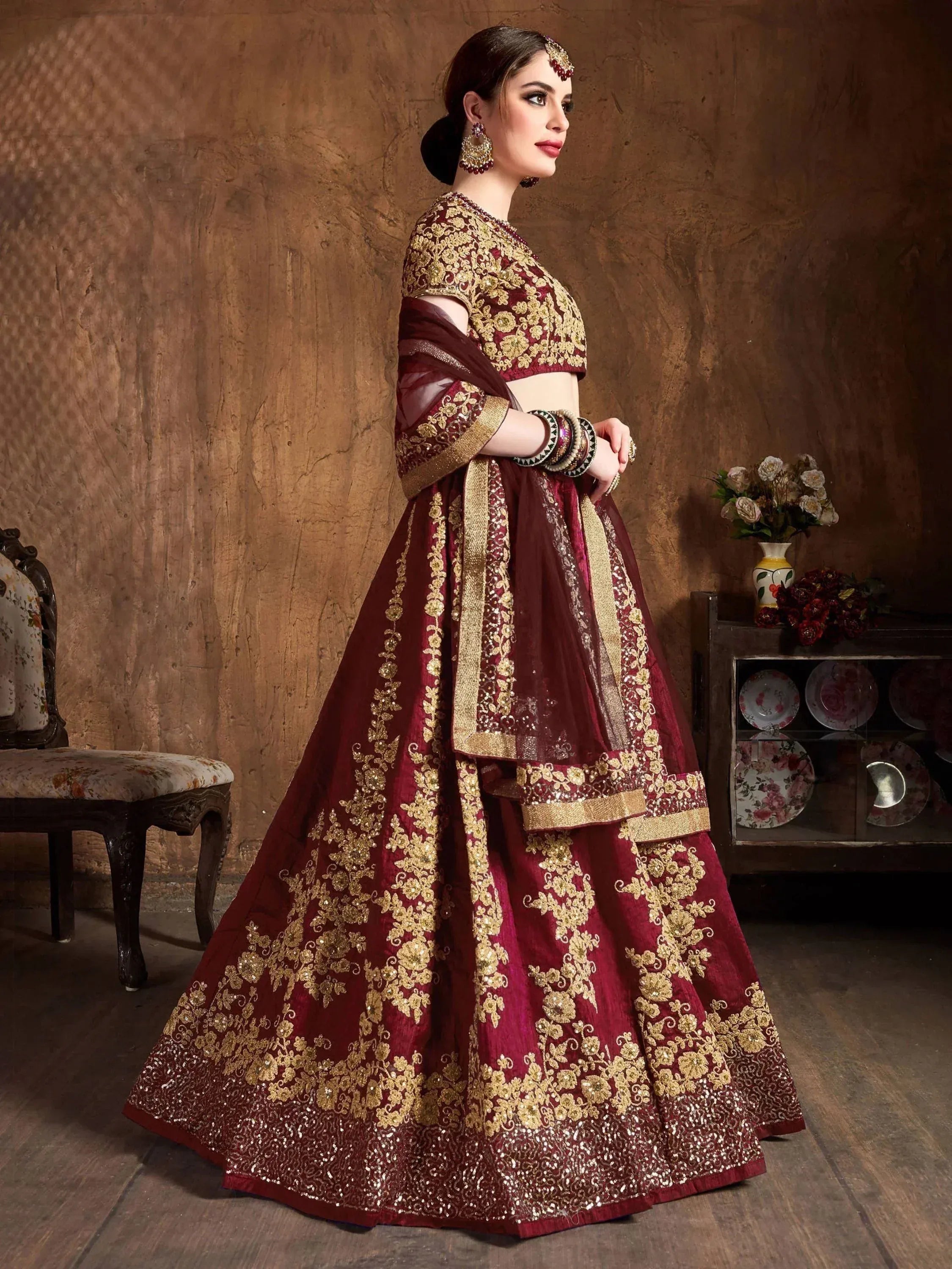 Maroon designer lehenga choli with gold embroidery, perfect for Indian weddings and festive occasions