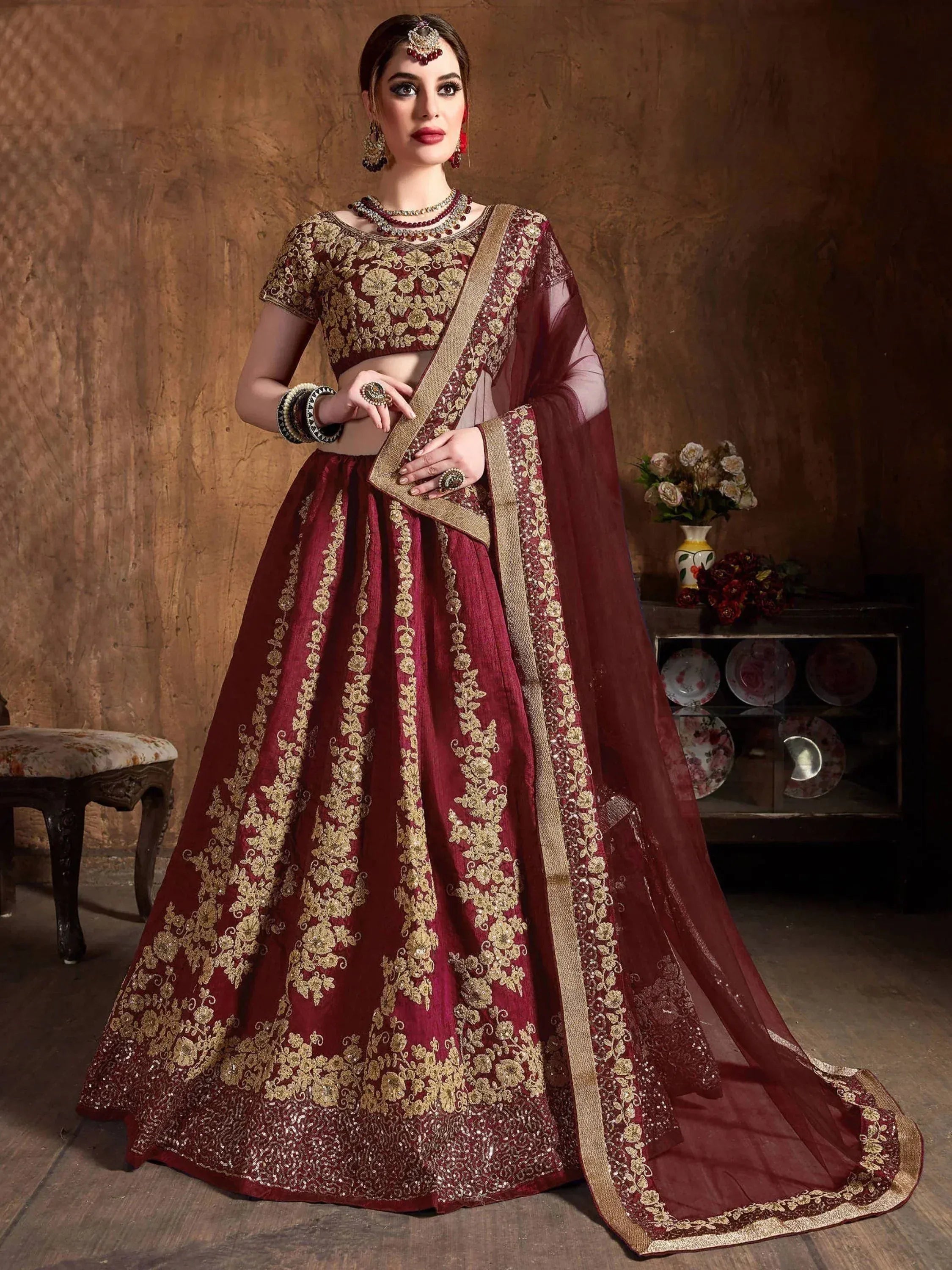 Maroon designer lehenga choli with gold embroidery, perfect for weddings and festive occasions