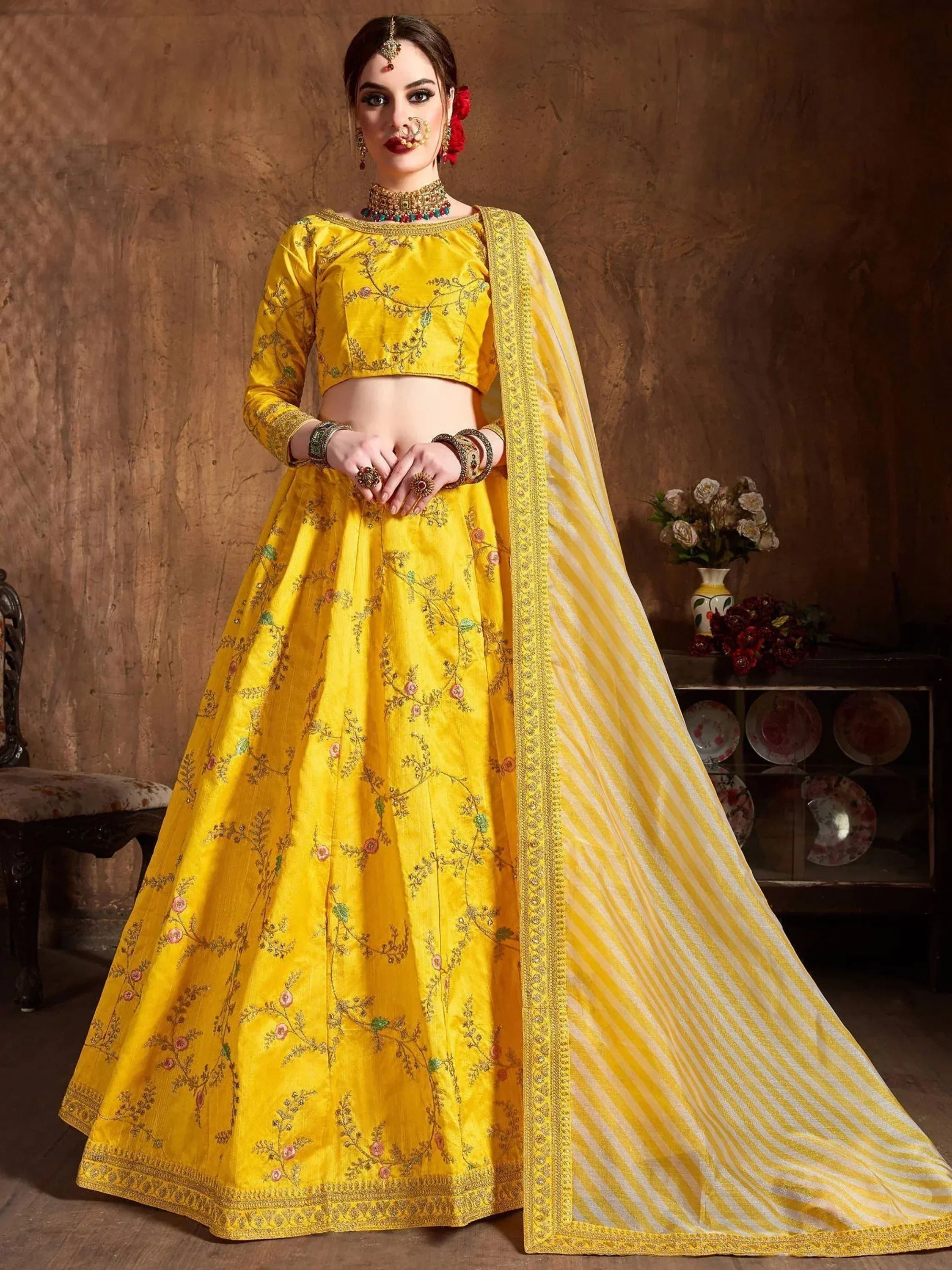 Yellow embroidered lehenga choli with floral design and striped dupatta, perfect for Indian ethnic occasions
