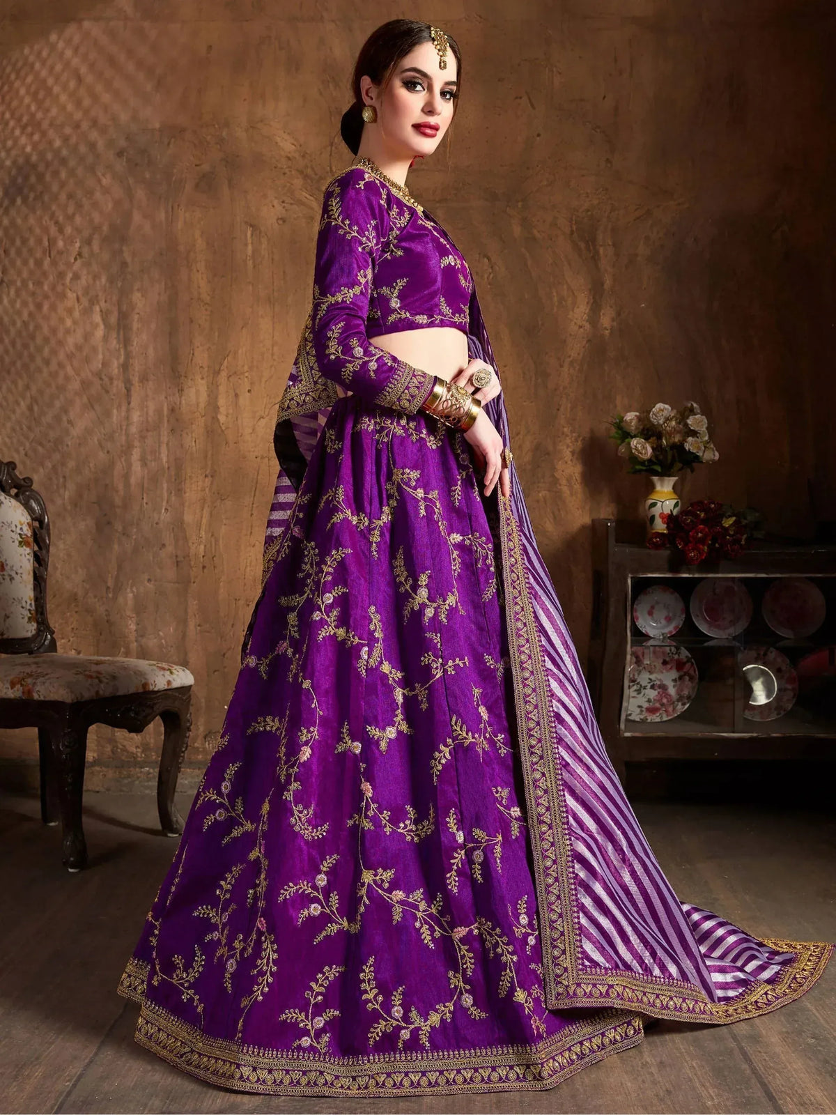 Purple embroidered lehenga choli with gold detailing, perfect for Indian ethnic wear and festive occasions.