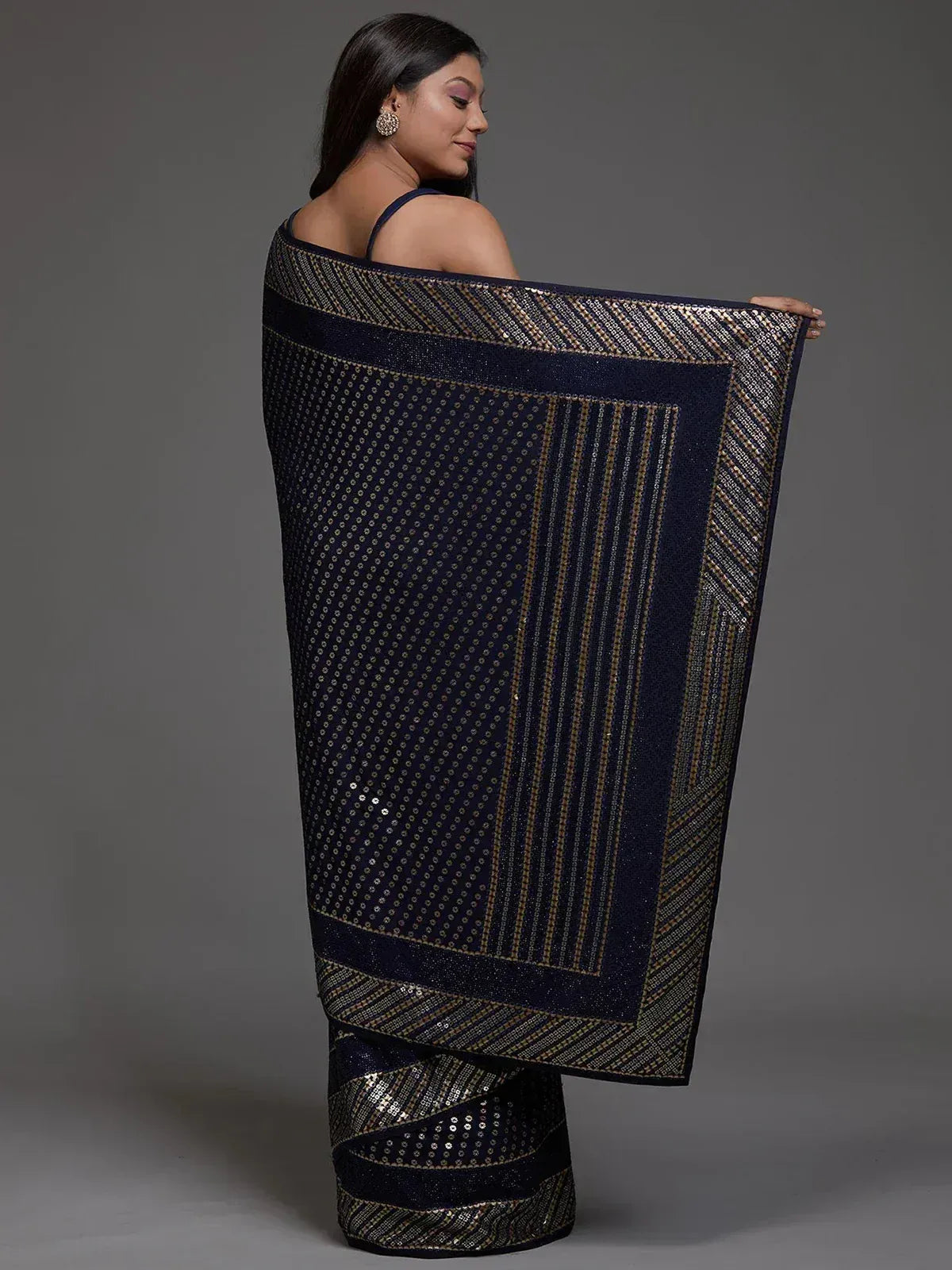 Elegant navy blue saree with gold sequin detailing and geometric patterns, perfect for ethnic occasions.