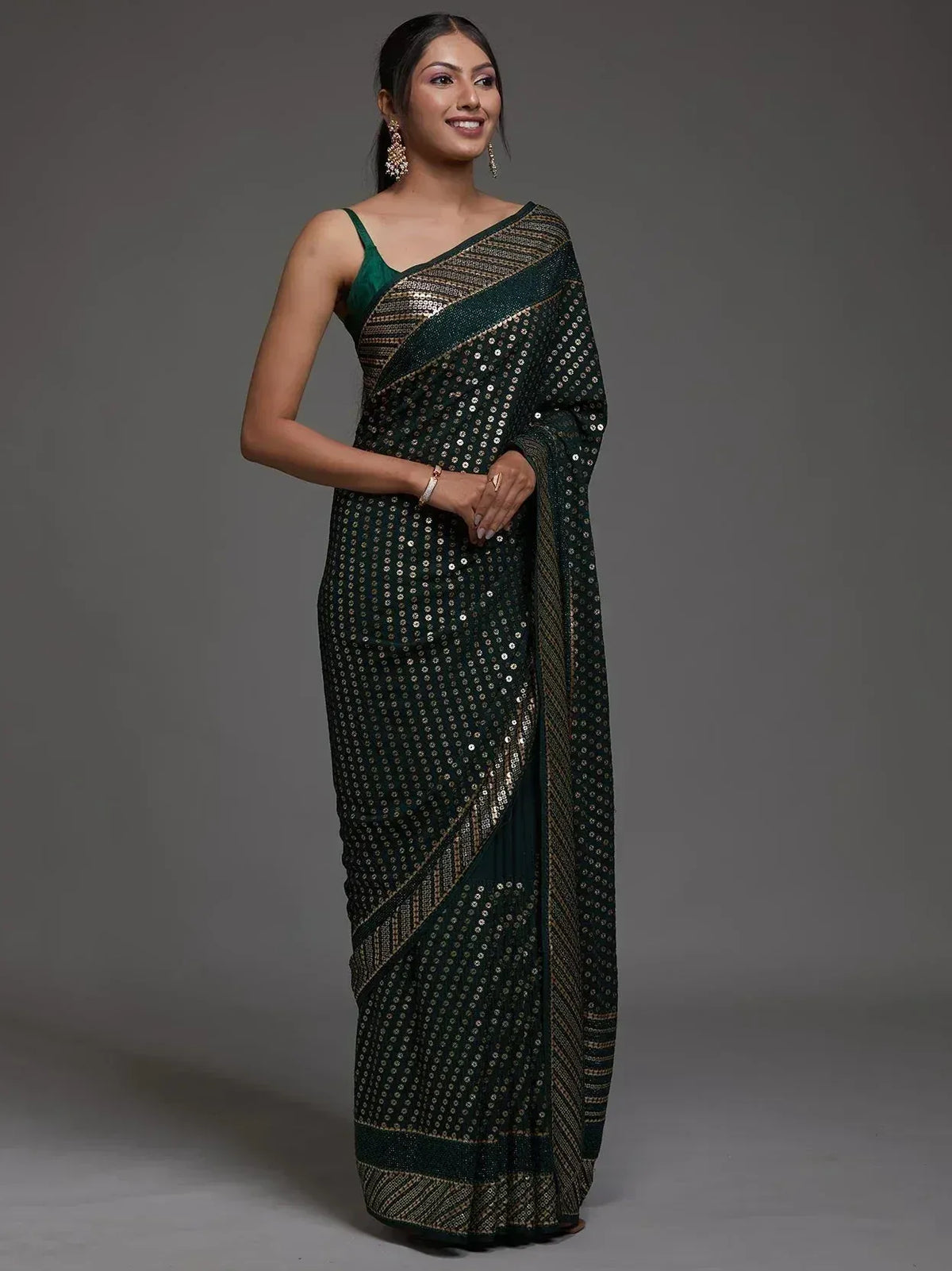 Elegant green saree with sequin detailing and gold border, perfect for ethnic occasions