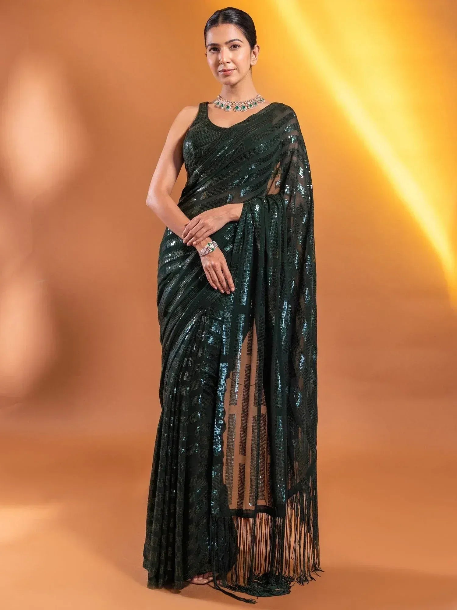 Emerald green sequin saree with fringe detailing, perfect for Indian ethnic occasions and festive wear.
