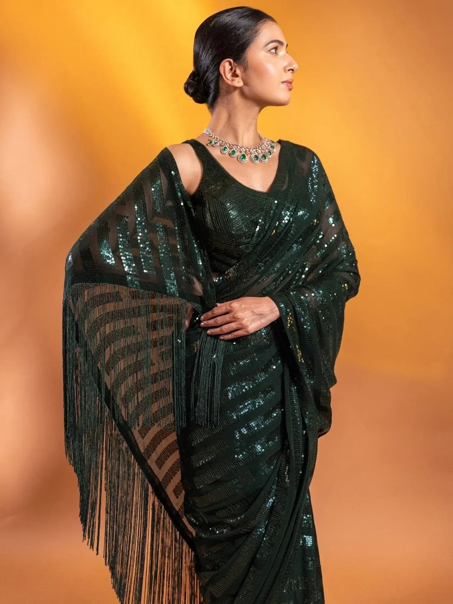 Emerald green sequin saree with fringe border, perfect for Indian ethnic occasions and festive wear.