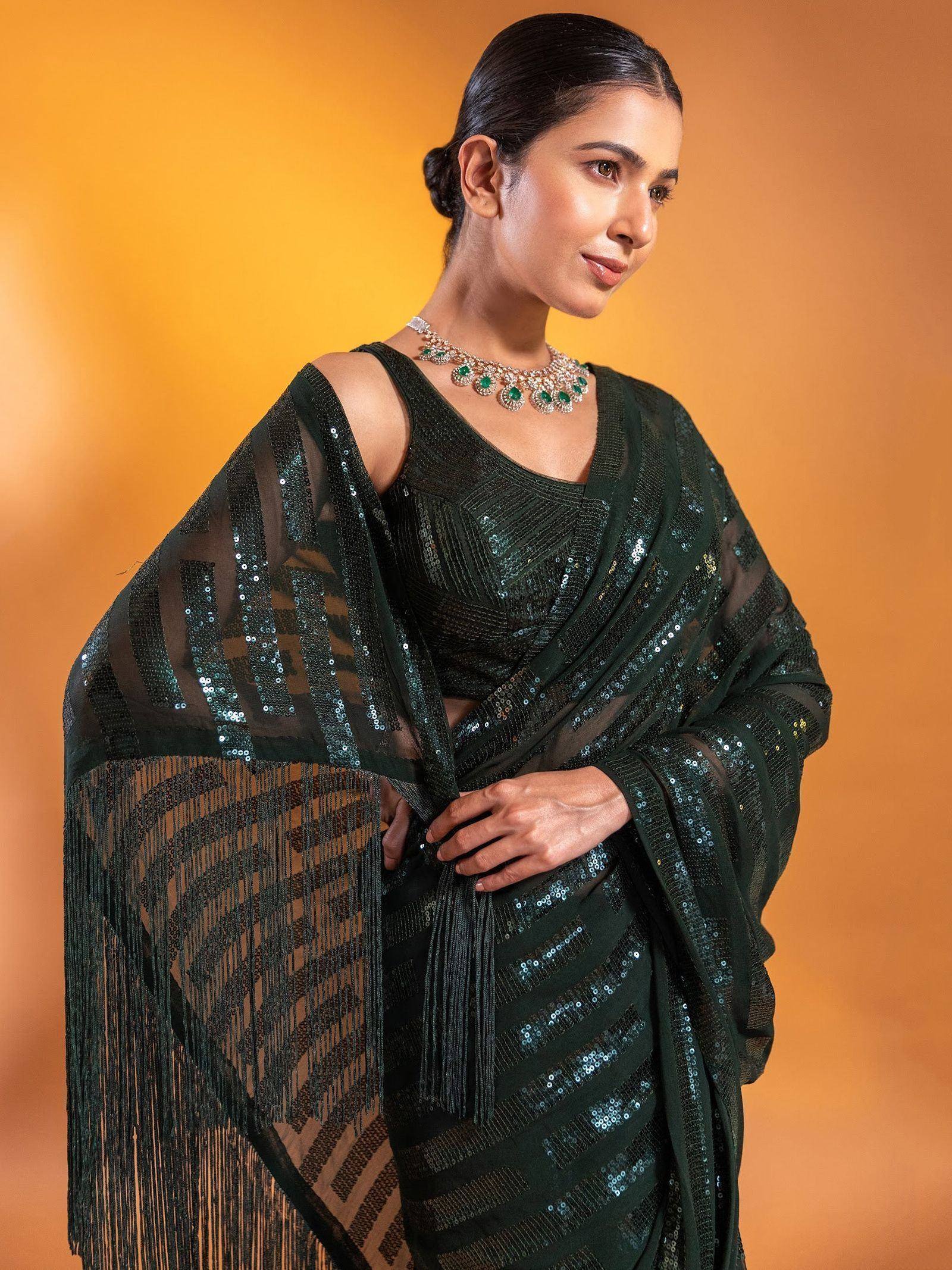 Elegant dark green sequin saree with fringe detailing, perfect for Indian ethnic wear occasions