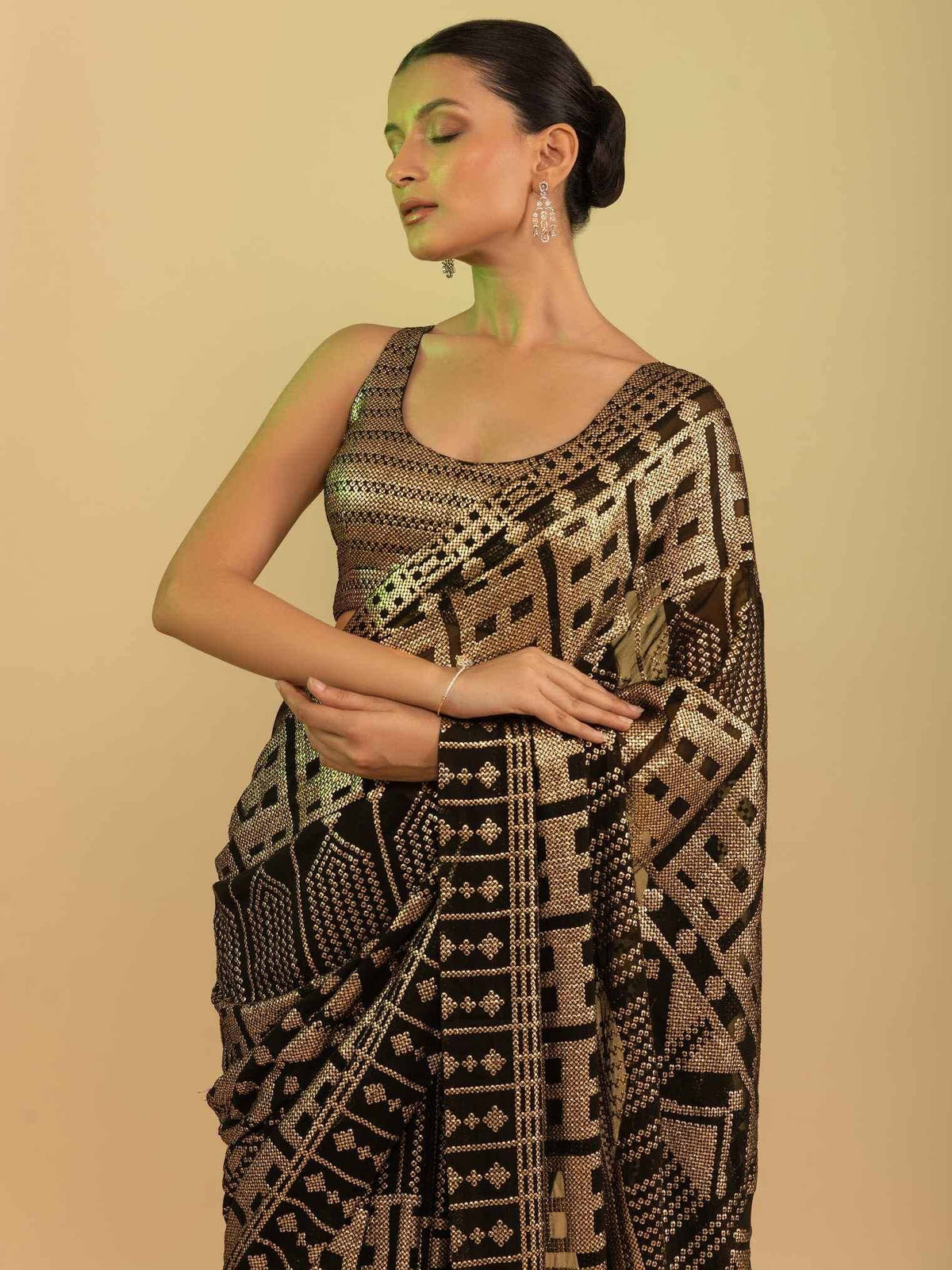 Black and gold geometric patterned saree with matching blouse, elegant ethnic wear for women