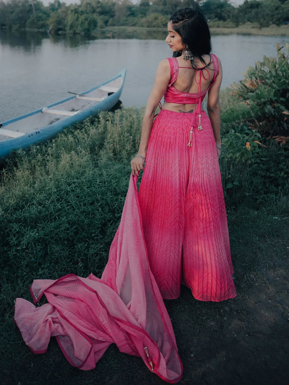 Pink designer lehenga choli with back tie, paired with matching dupatta, near lakeside