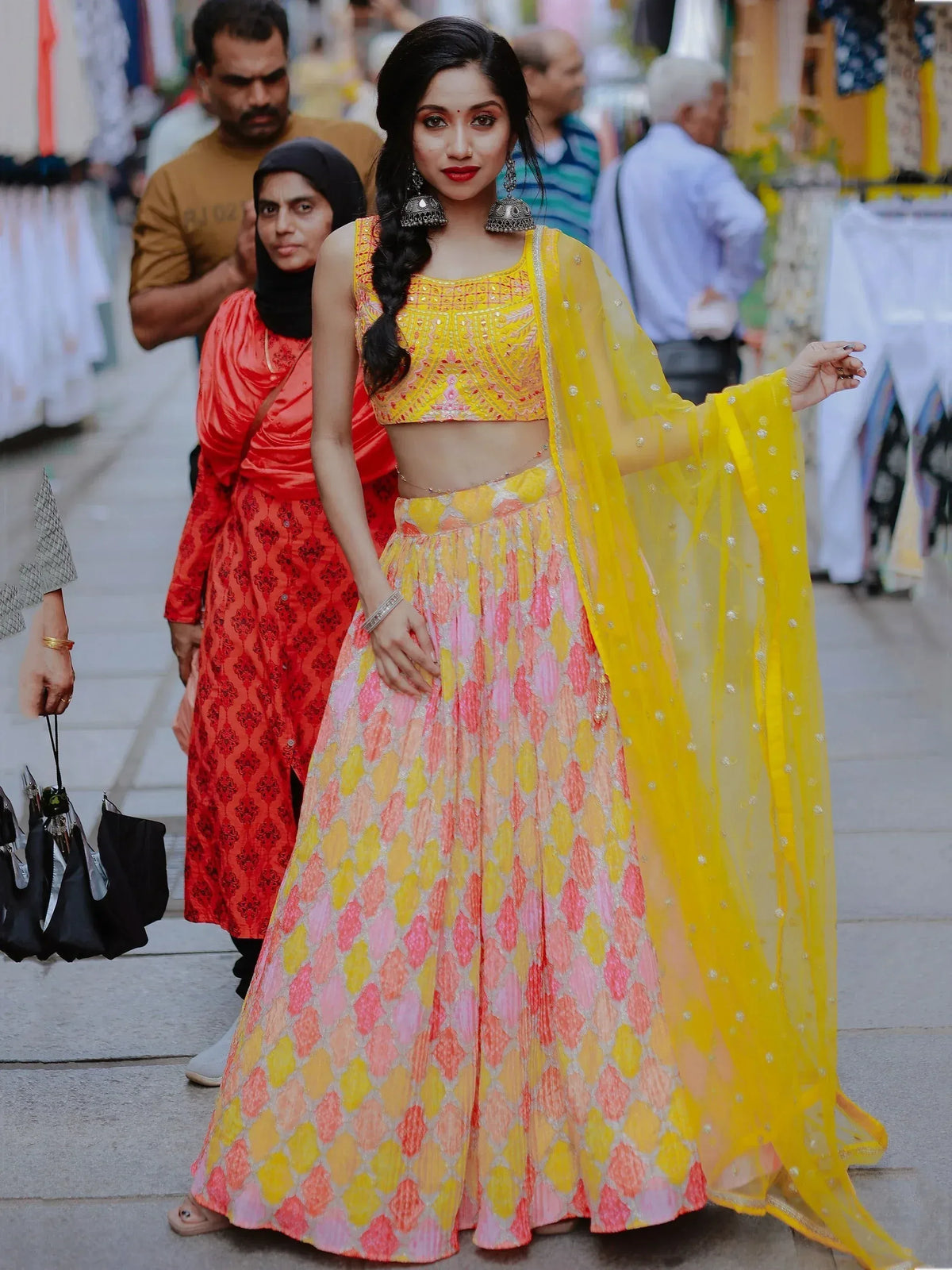 Vibrant yellow and pink lehenga choli with intricate embroidery, perfect for festive occasions and Indian celebrations.