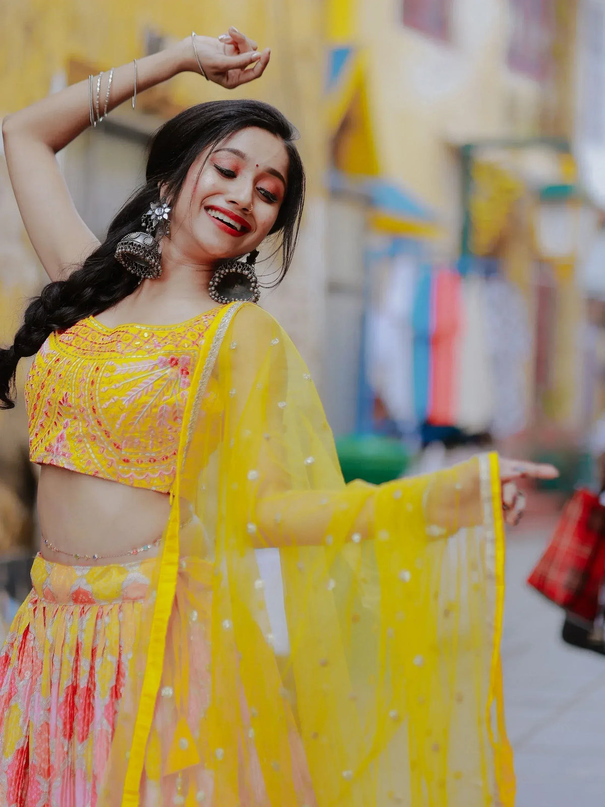 Vibrant yellow lehenga choli with floral embroidery and sheer dupatta, perfect for festive occasions.