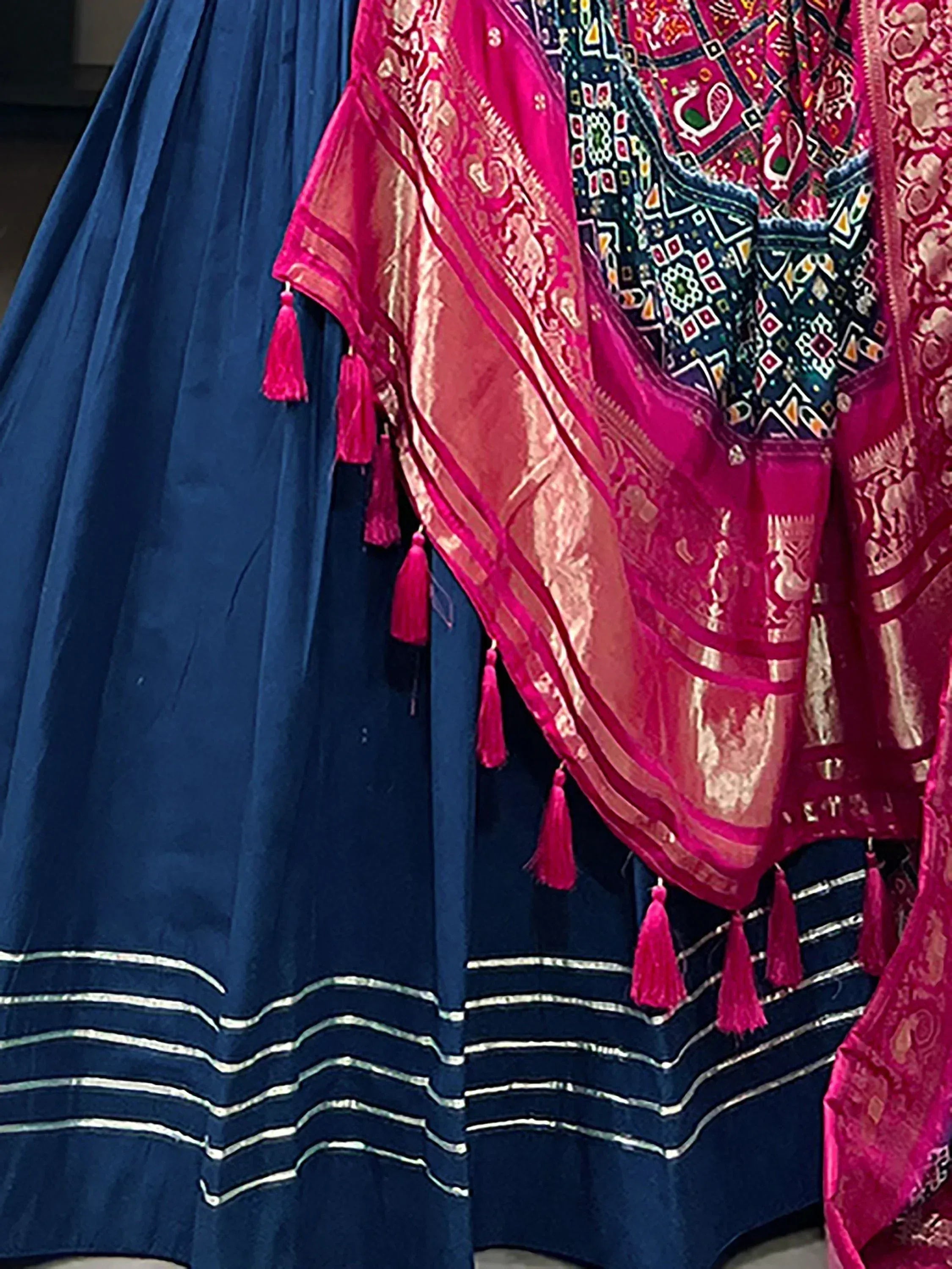 Blue velvet lehenga with silver border and pink embroidered dupatta with tassels, Indian ethnic wear