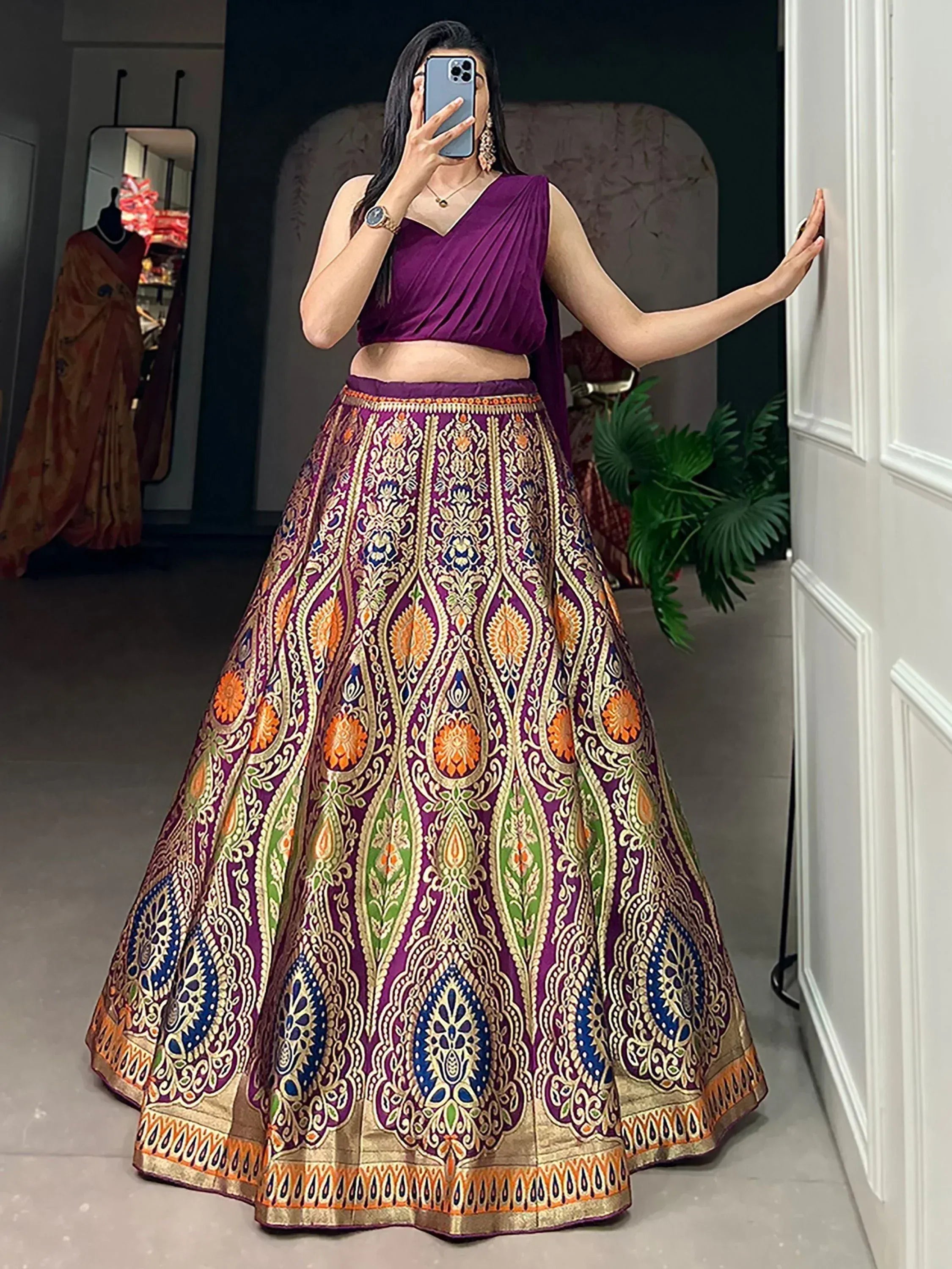 Purple designer lehenga choli with intricate gold and colorful embroidery, perfect for Indian ethnic wear