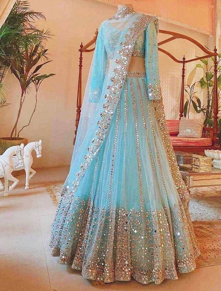 Light blue designer lehenga choli with gold mirror work and sheer dupatta, perfect for Indian weddings