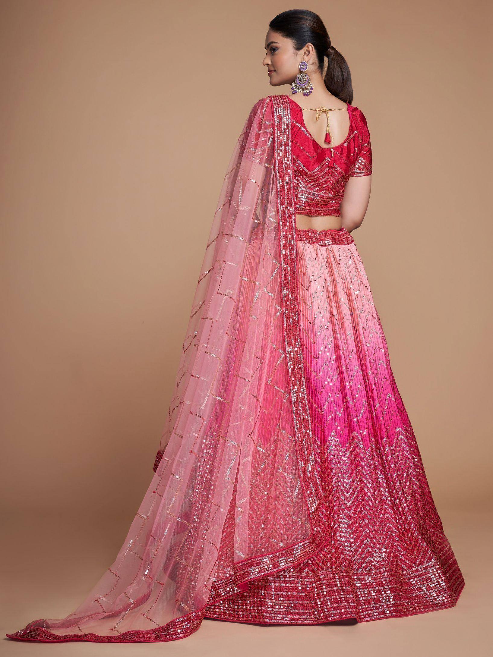 Pink and red sequined lehenga choli with sheer dupatta, perfect for Indian weddings and festive occasions.