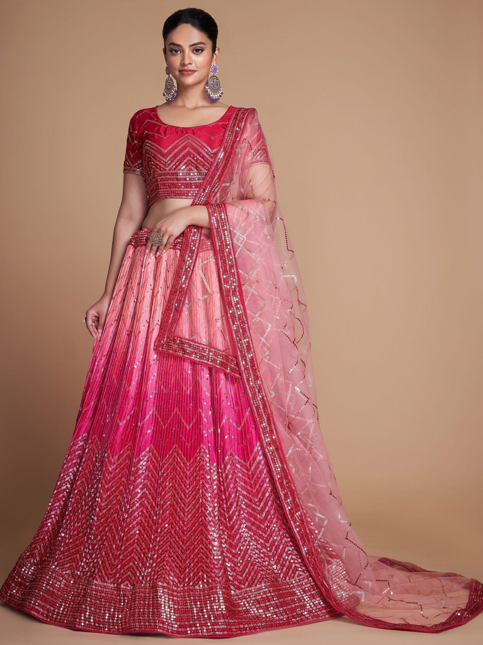 Pink and red sequined lehenga choli with geometric embroidery, perfect for Indian weddings and festive occasions