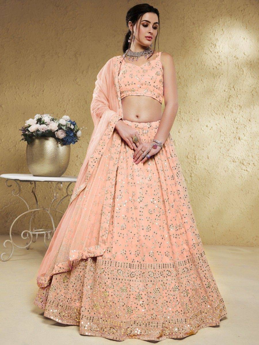 Peach designer lehenga choli with floral embroidery and sequin detailing, perfect for Indian ethnic occasions.