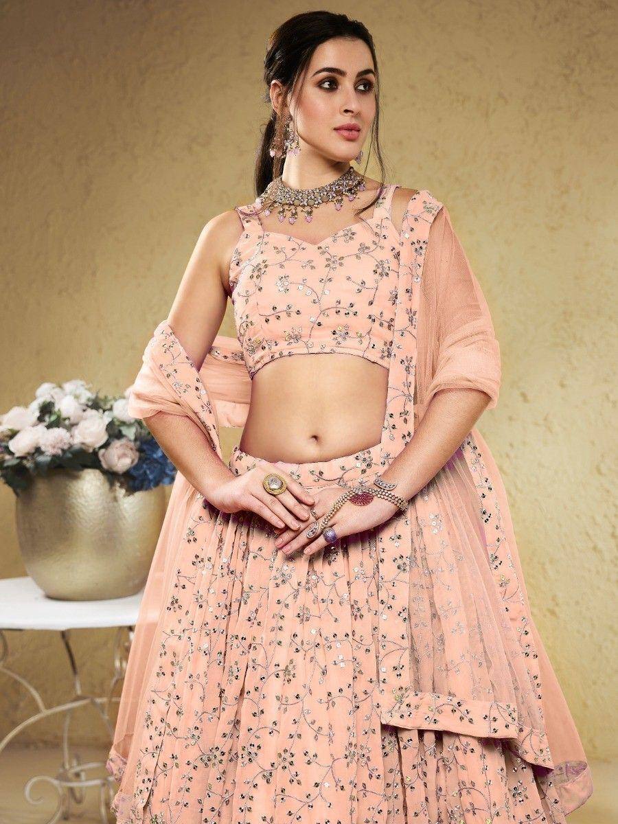 Pink embroidered lehenga choli with floral embellishments, perfect for Indian ethnic occasions