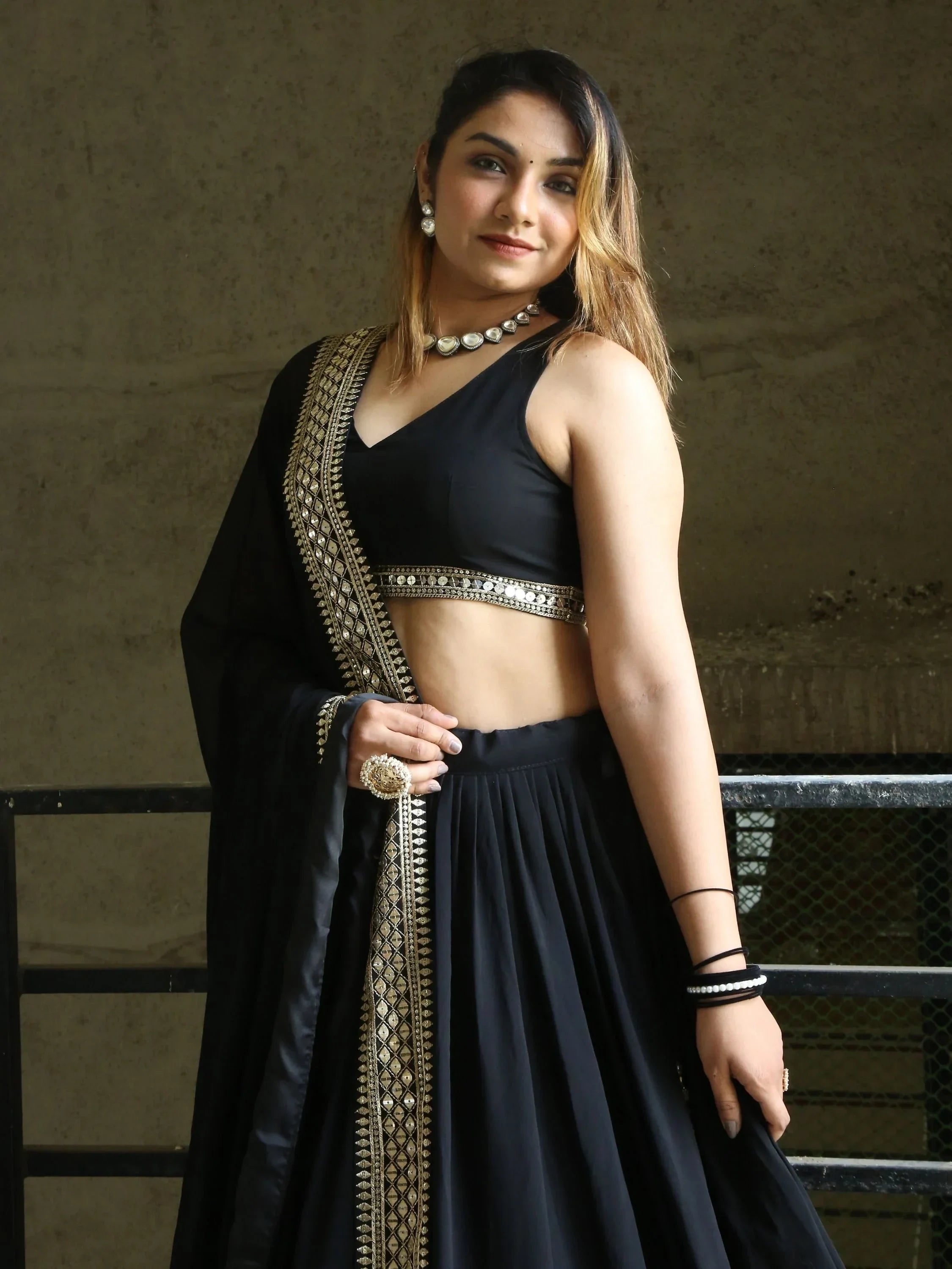 Black lehenga choli with gold embroidery and mirror work, perfect for Indian ethnic wear occasions