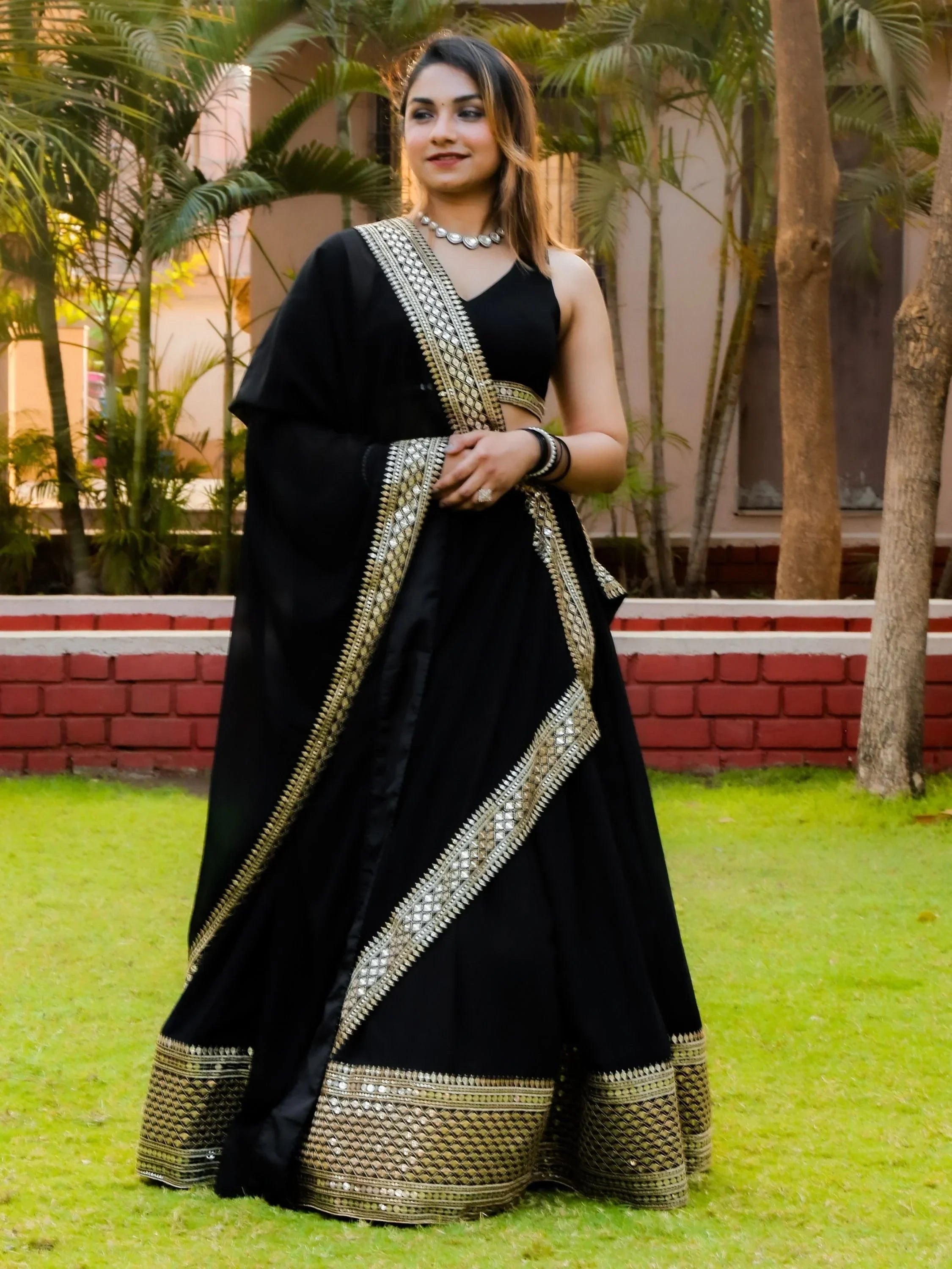 Black designer lehenga choli with gold mirror work, perfect for Indian ethnic wear occasions