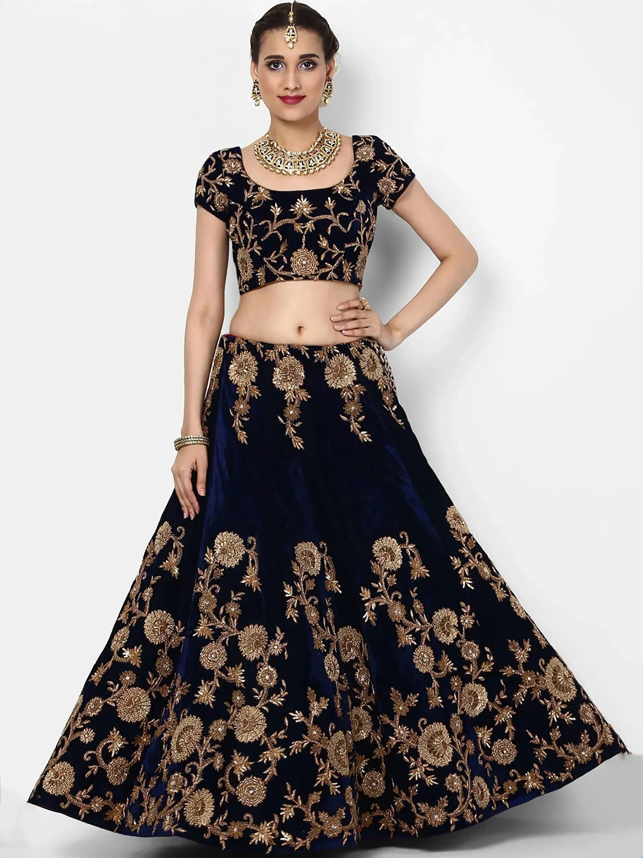 Navy blue velvet lehenga choli with gold floral embroidery, perfect for Indian weddings and festive occasions.