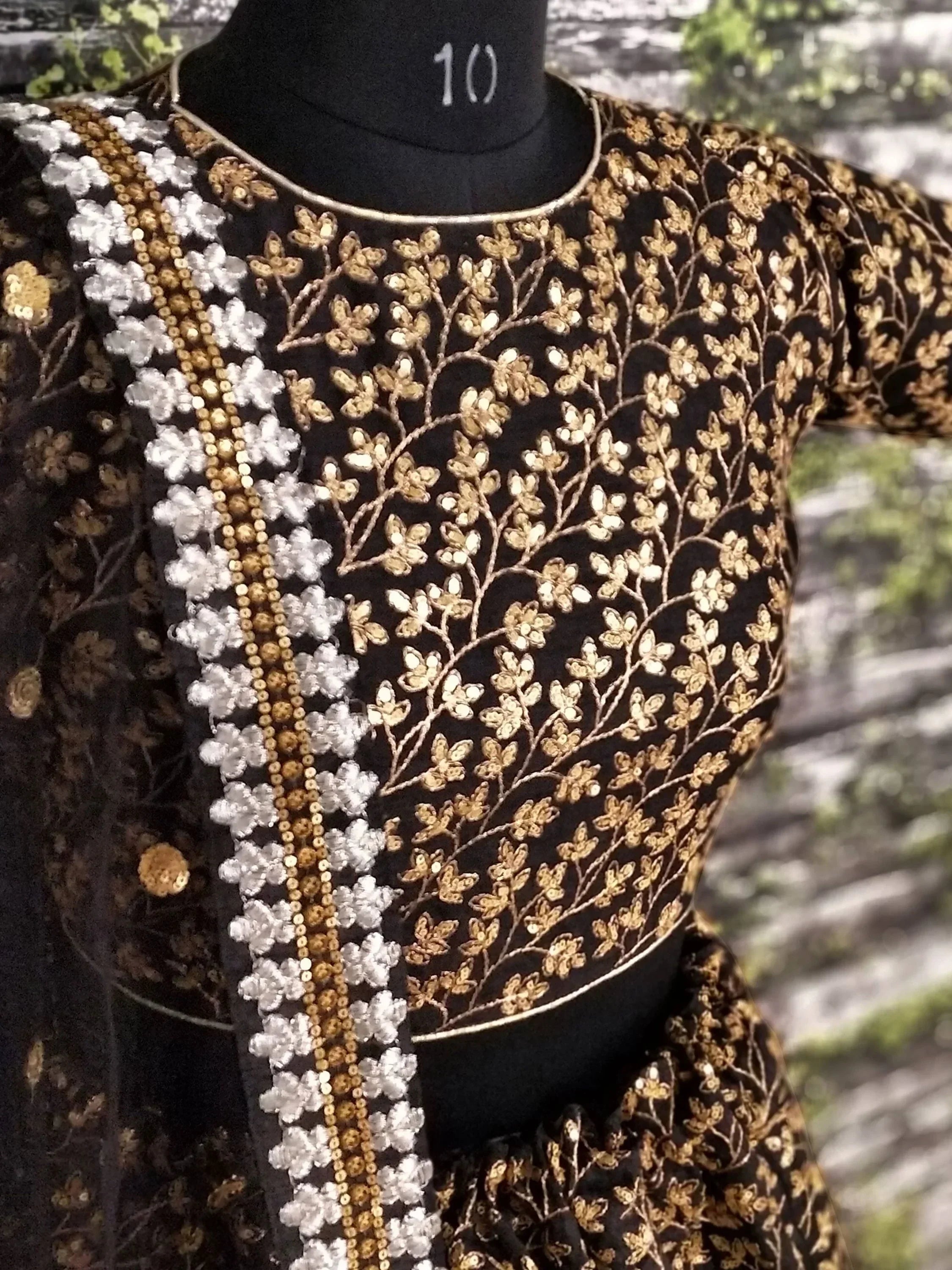 Black ethnic gown with gold and white floral embroidery, perfect for Indian weddings or festive occasions.