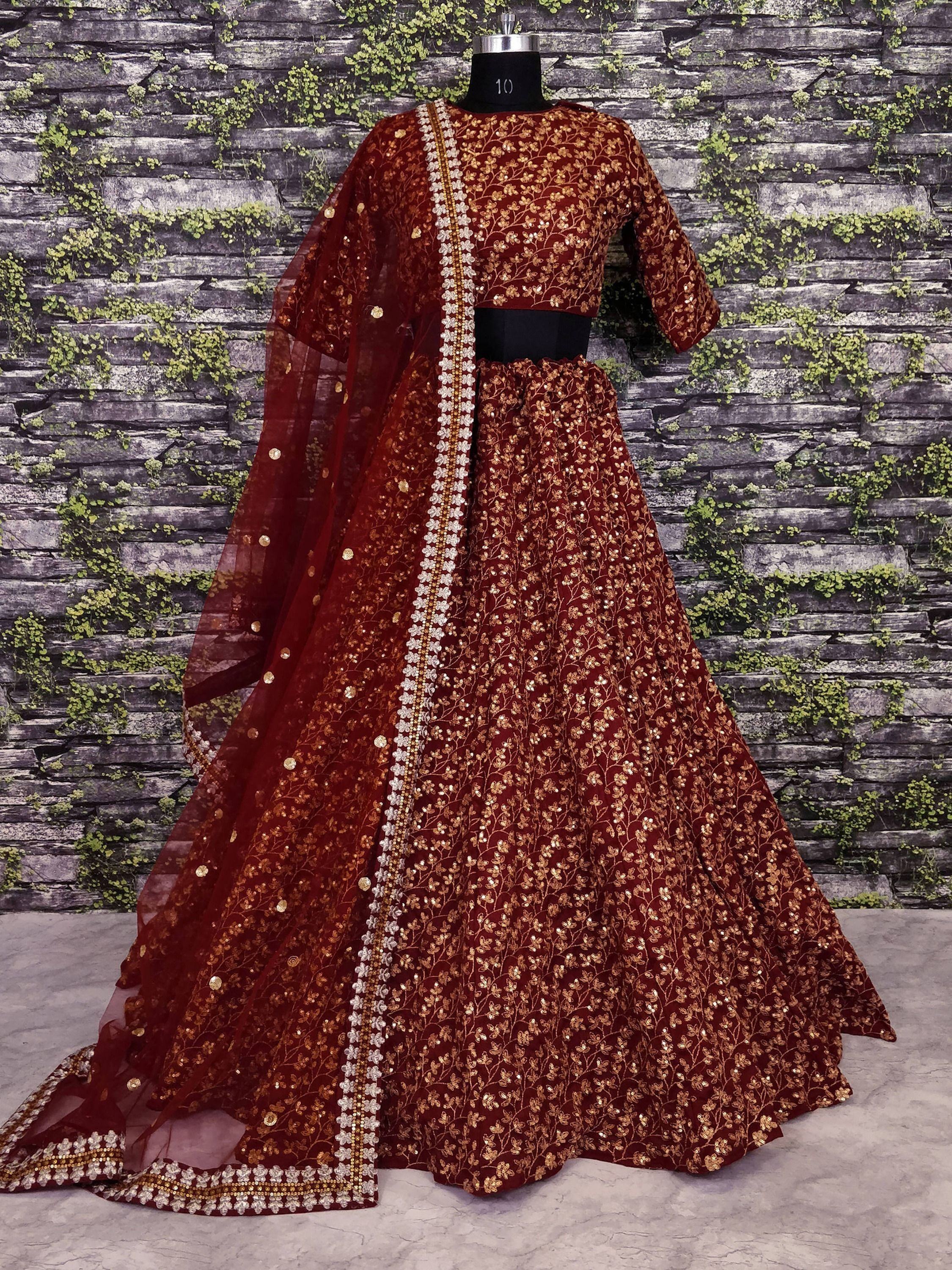 Maroon designer lehenga choli with gold floral embroidery and sequins, perfect for Indian weddings and festive occasions.