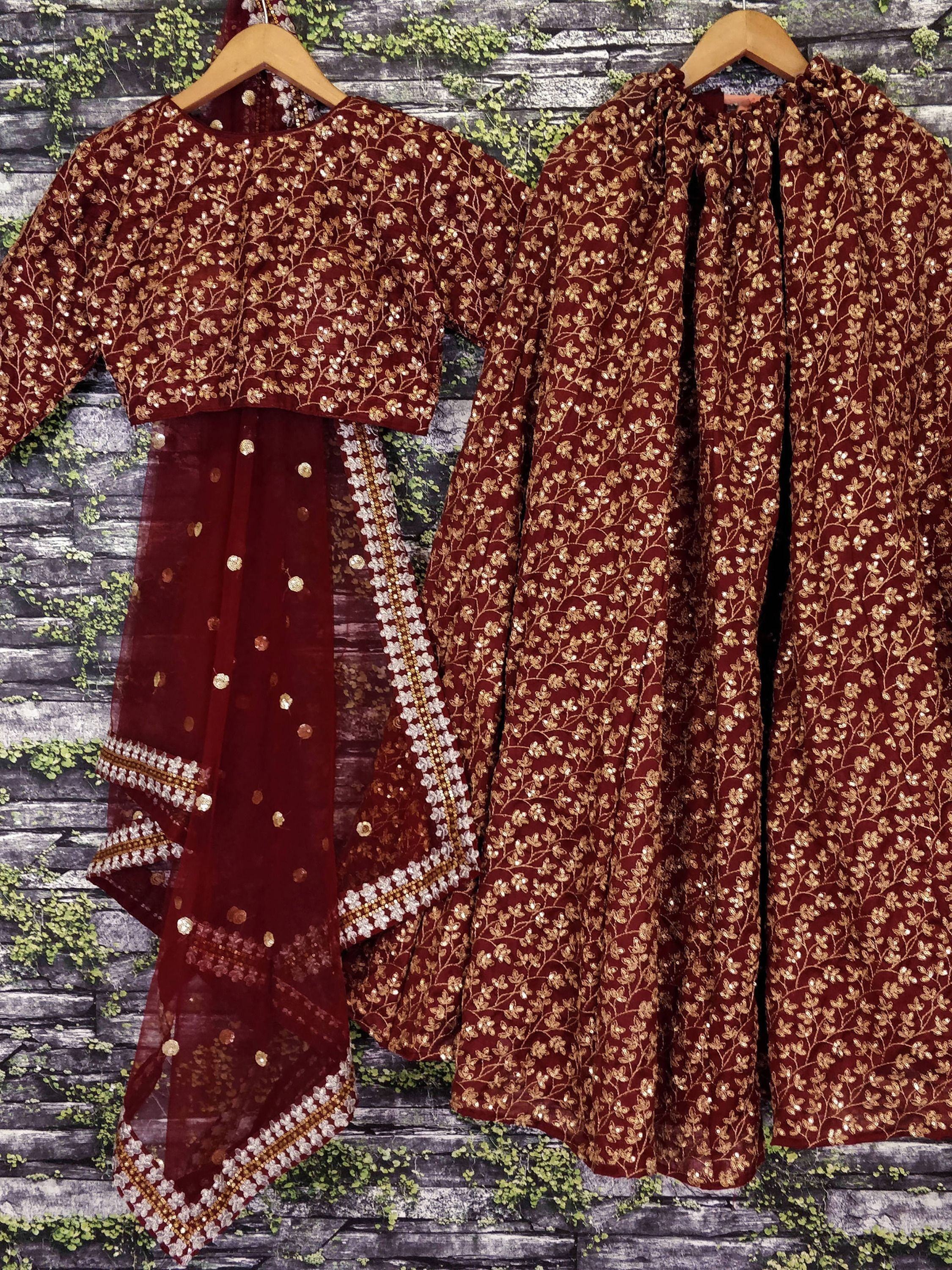 Maroon ethnic sharara set with gold floral embroidery and sequins, perfect for Indian celebrations